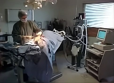 Dog undergoing veterinary surgery on an operating table.
