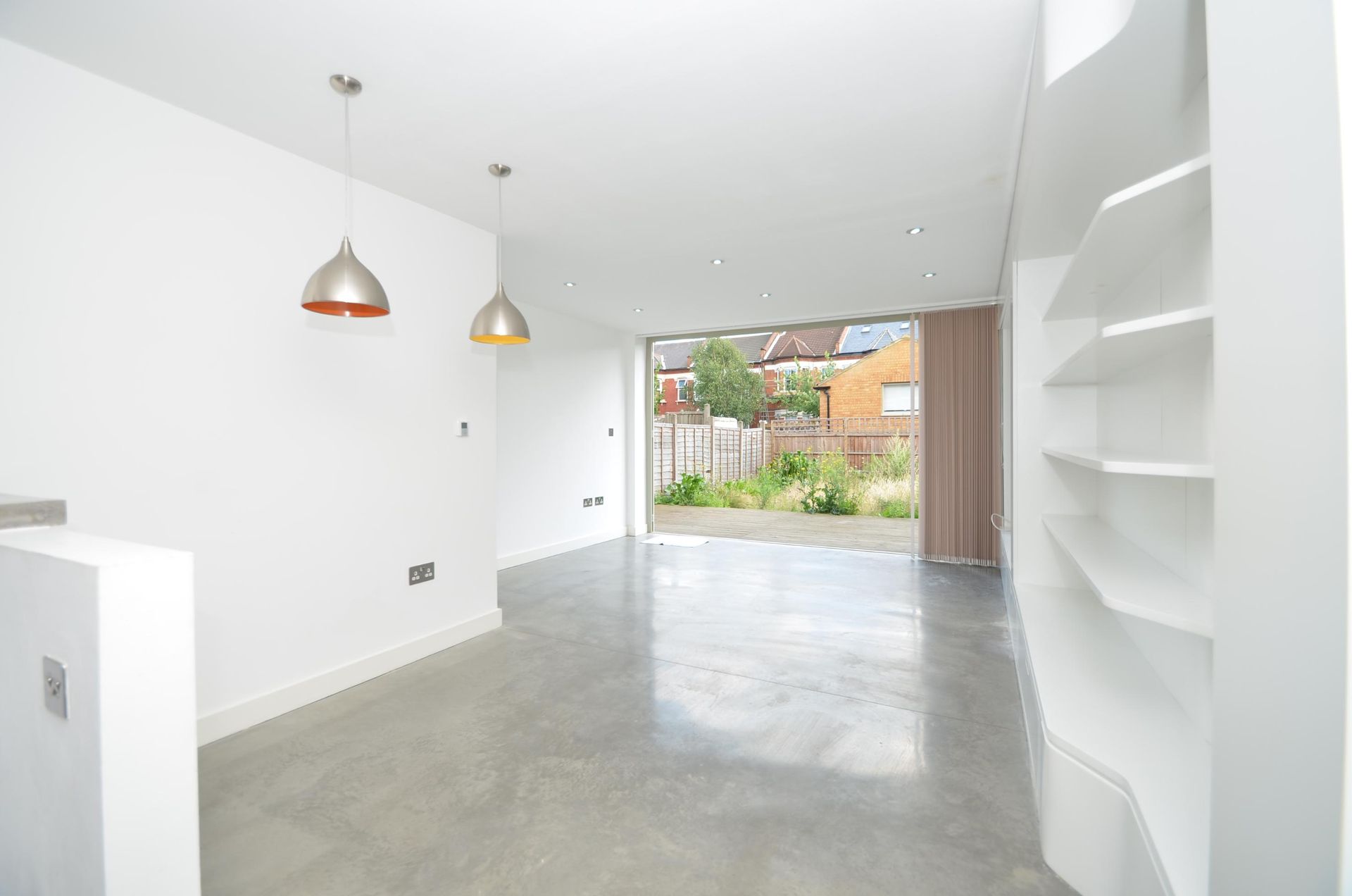 An Empty Room with A Concrete Floor and White Walls — Next Level Construction Contractors in Cootamundra, NSW