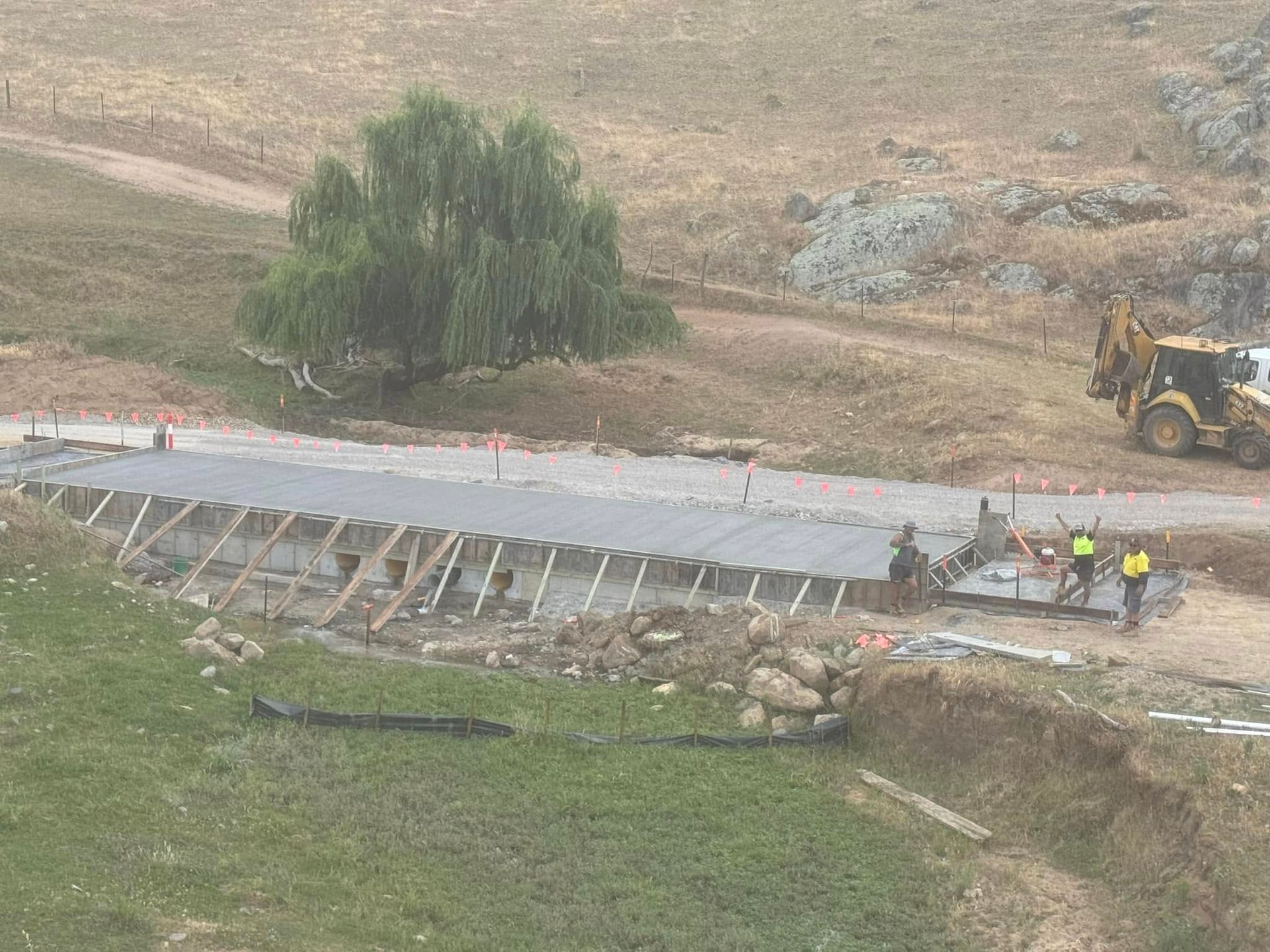 A Concrete Walkway Is Being Built on The Side of The Road — Next Level Construction Contractors in Gundagai, NSW