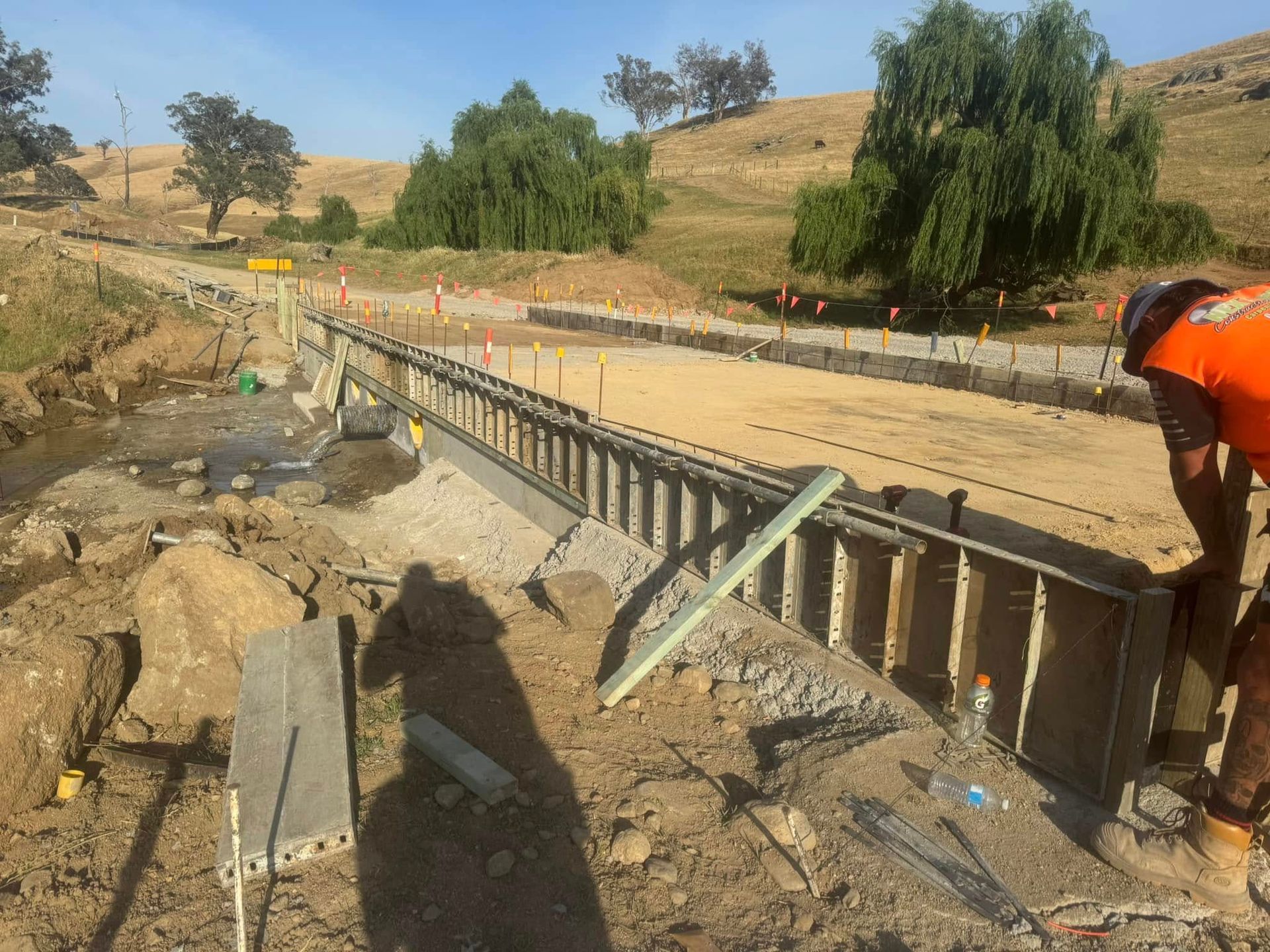 A Sliding Gate Is Open to A Driveway with Trees in The Background — Next Level Construction Contractors in Gundagai, NSW