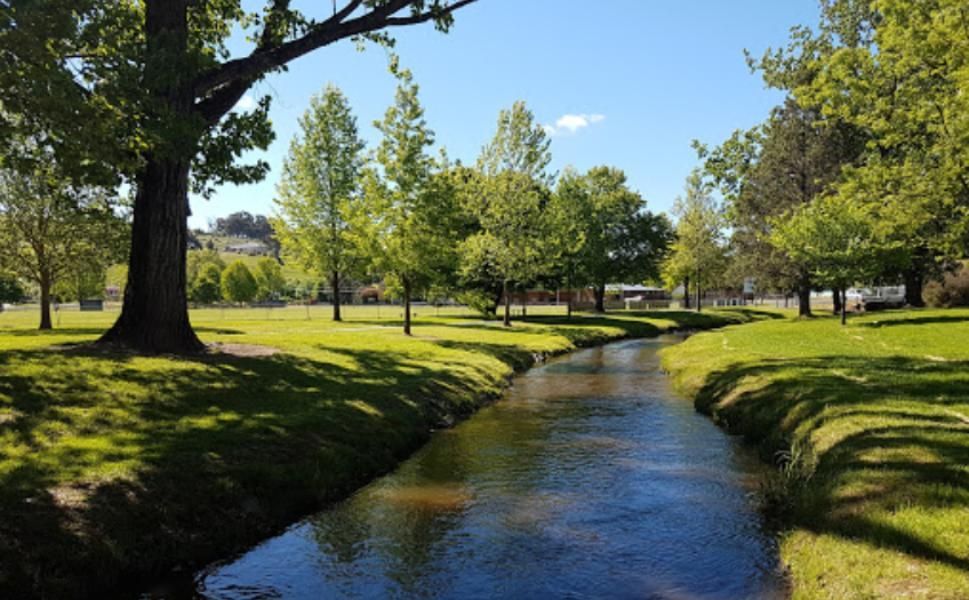 A Small Stream Running Through a Park Surrounded by Trees — Next Level Construction Contractors in Tumbarumba, NSW