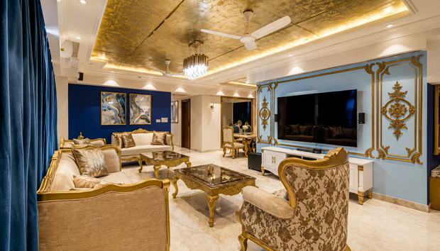 Furnished Apartments in Addis Ababa showcase a lavish gold-and-blue living room with ornate furniture, TV, and lighting.