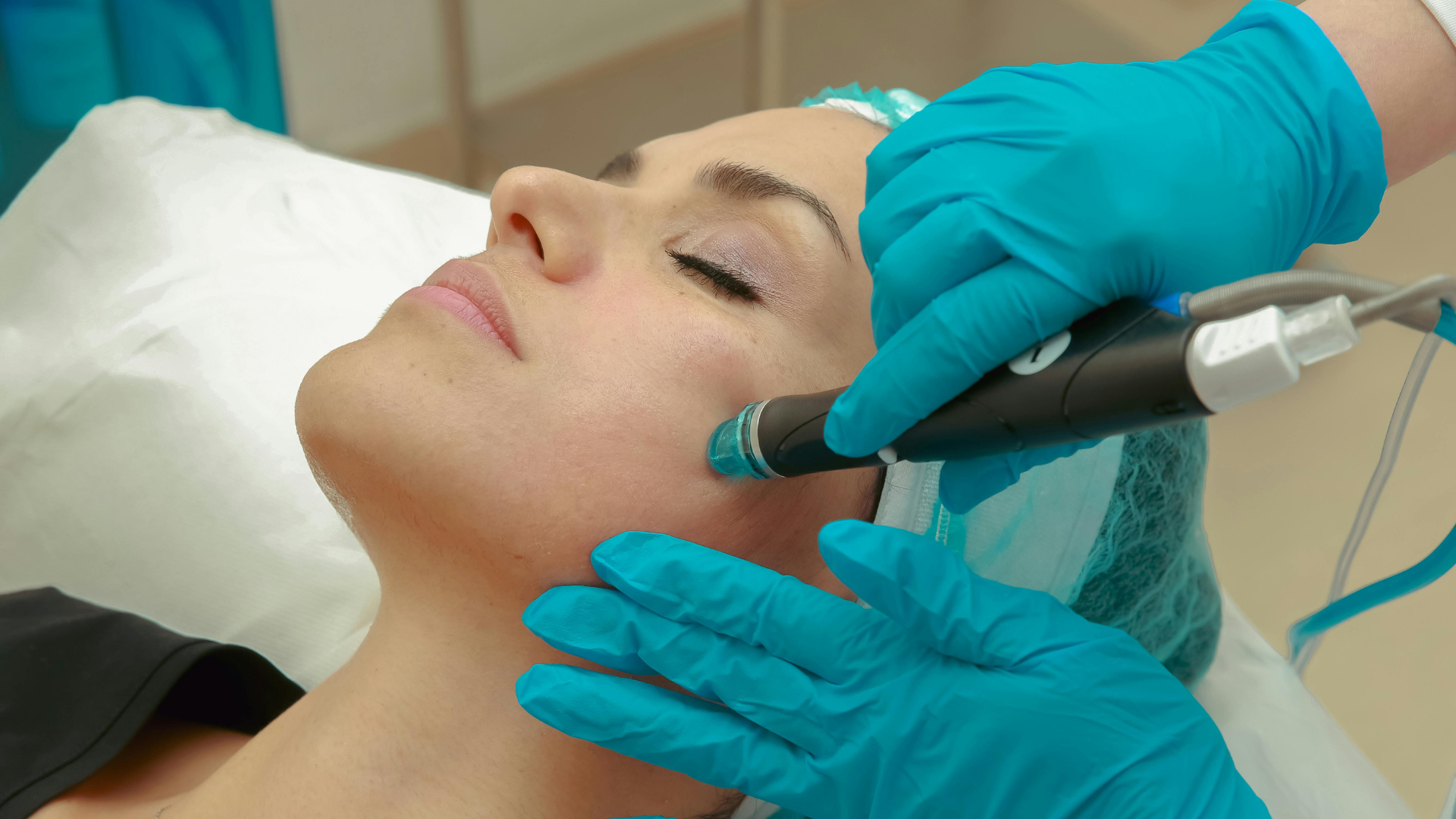 Lip augmentation procedure: a syringe injecting filler into a person's lip, against a purple backdrop.