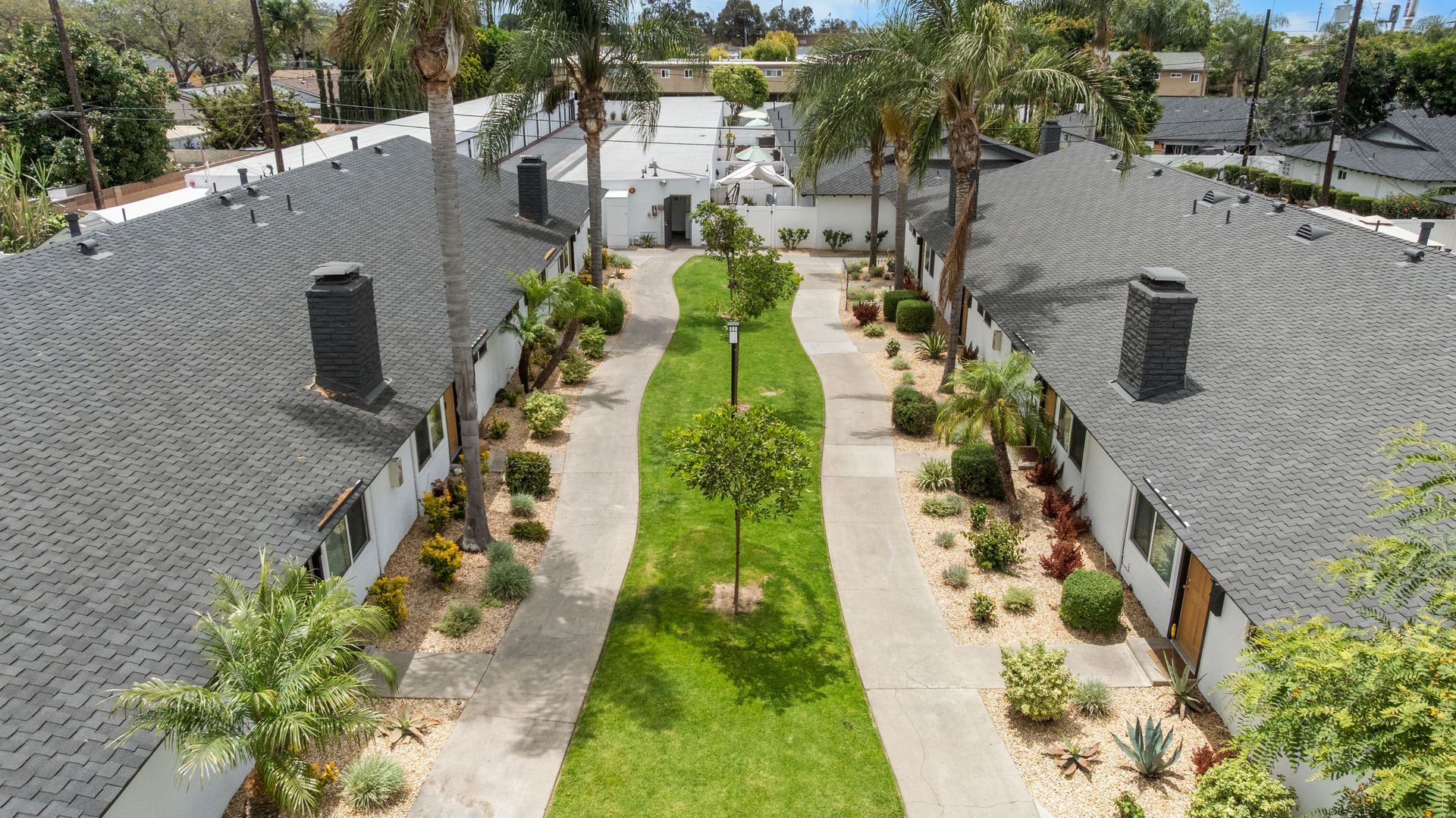 walkway through apartment buildings and landscaping at Washington Place 