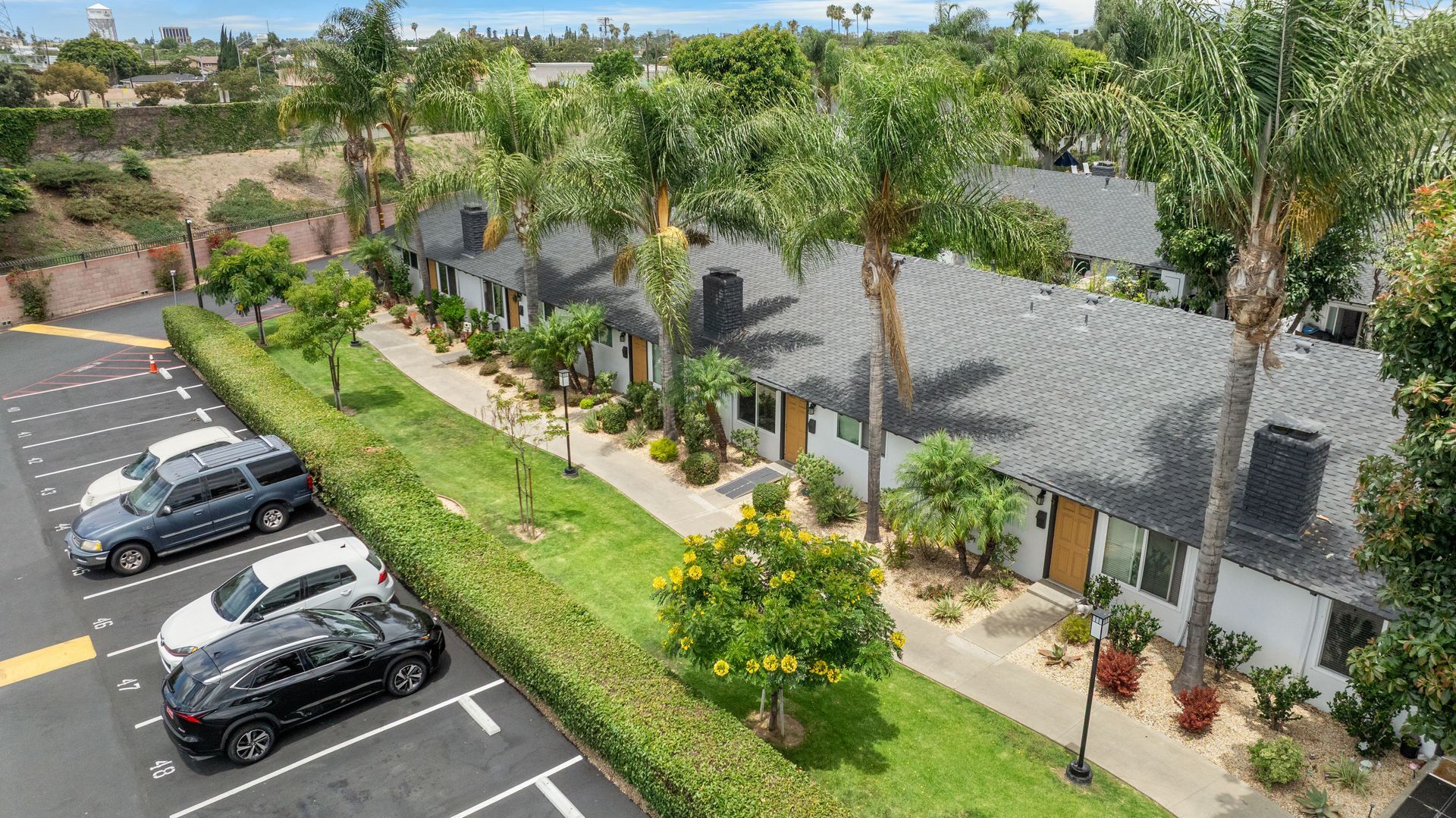 overhead view of front doors to apartments with grass and landscaping