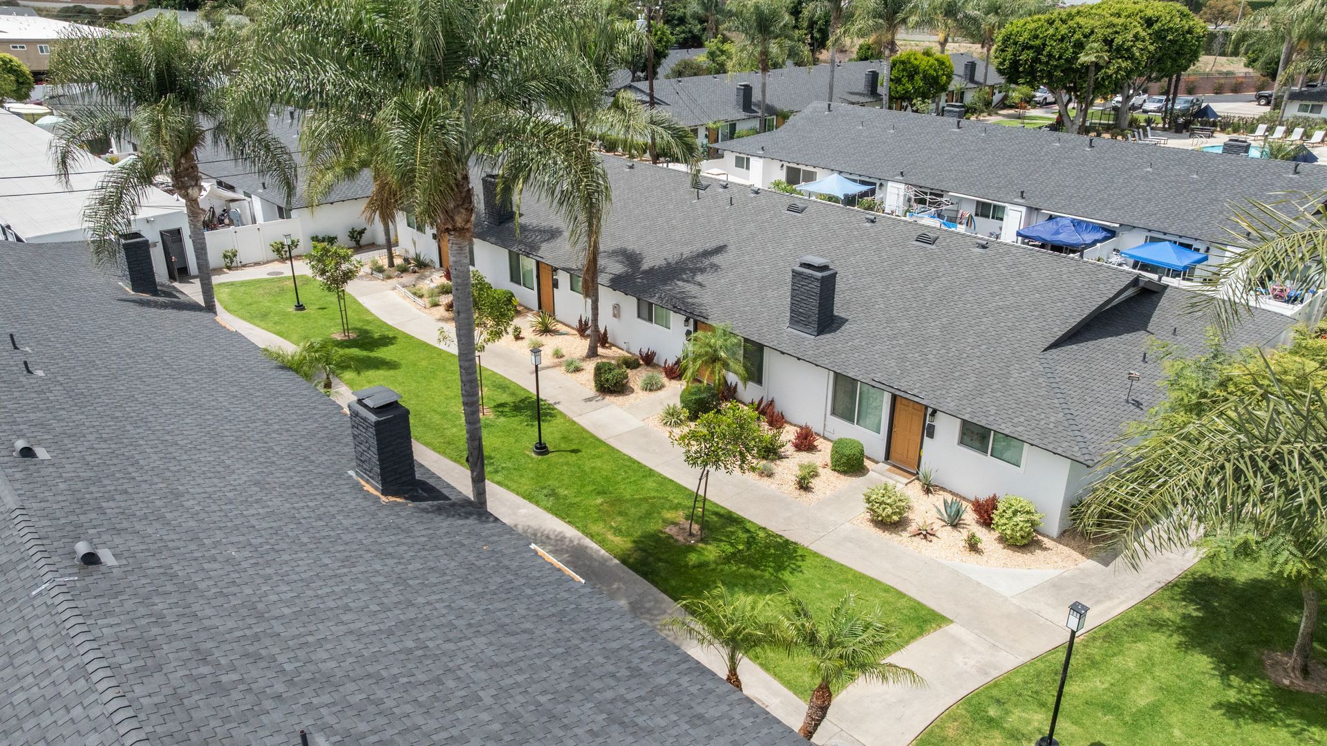 overhead view of front doors to apartments with grass and landscaping