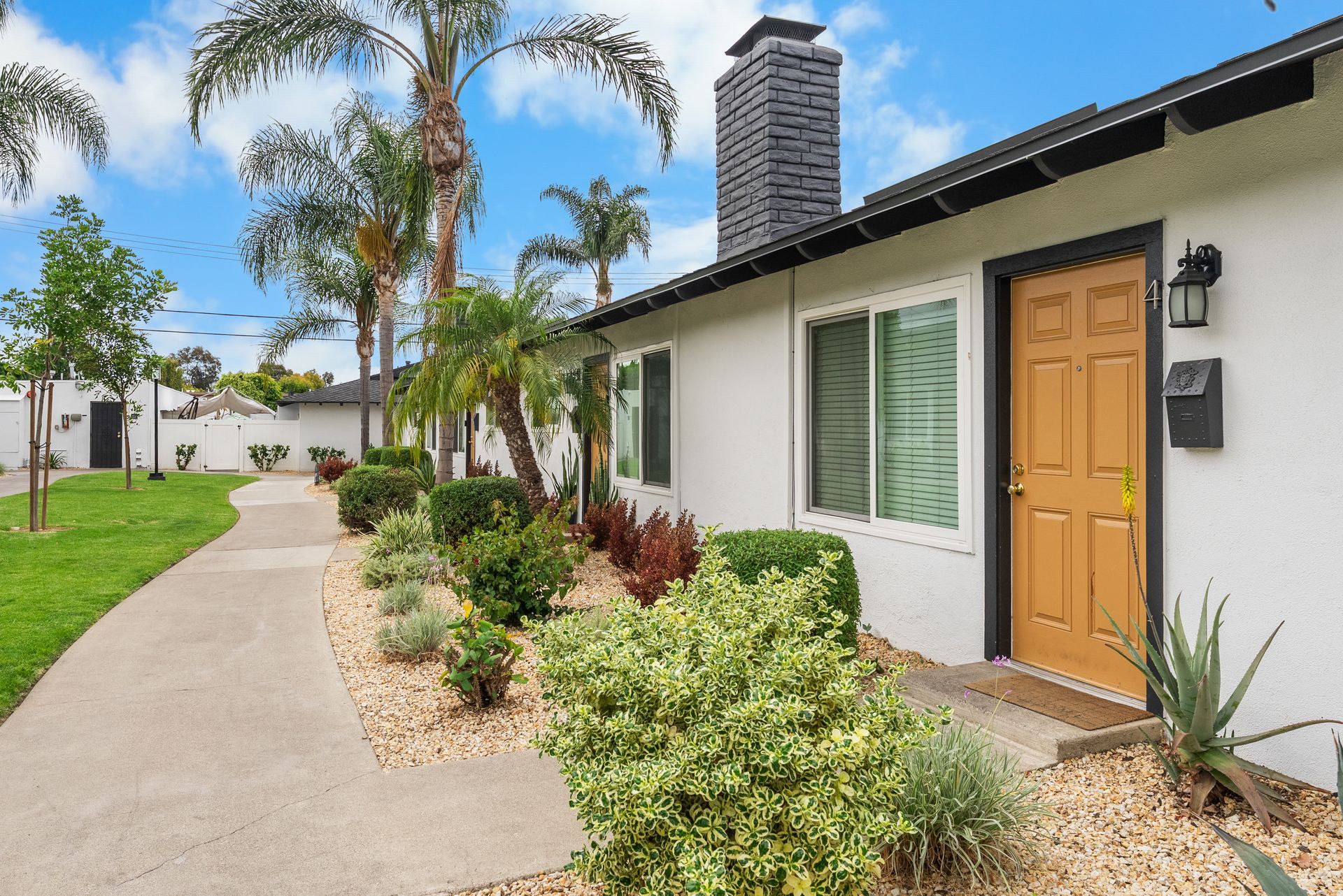 doorway to two-bedroom apartment and pathway with eco-friendly plants