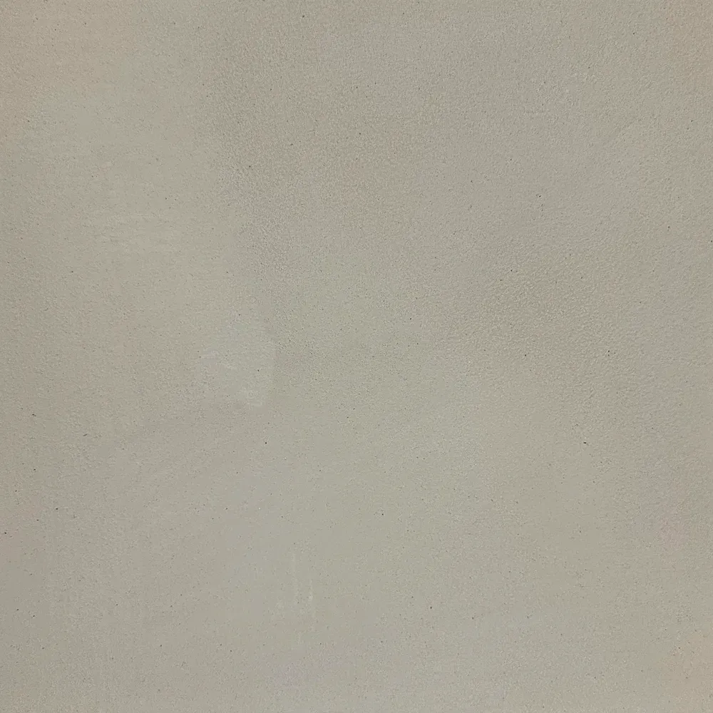 Plain beige wall with subtle texture and faint marks