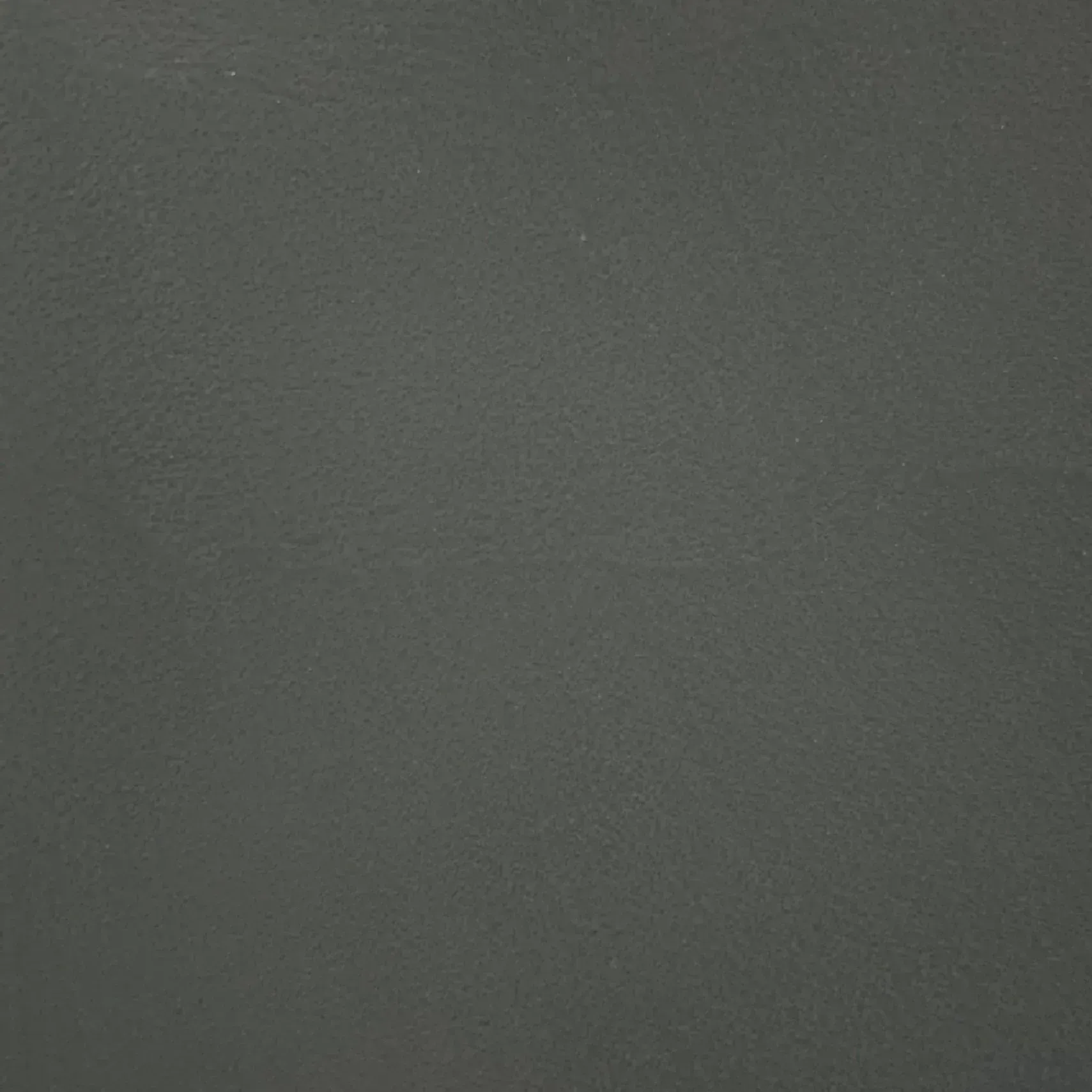 Dark gray textured surface with subtle speckling