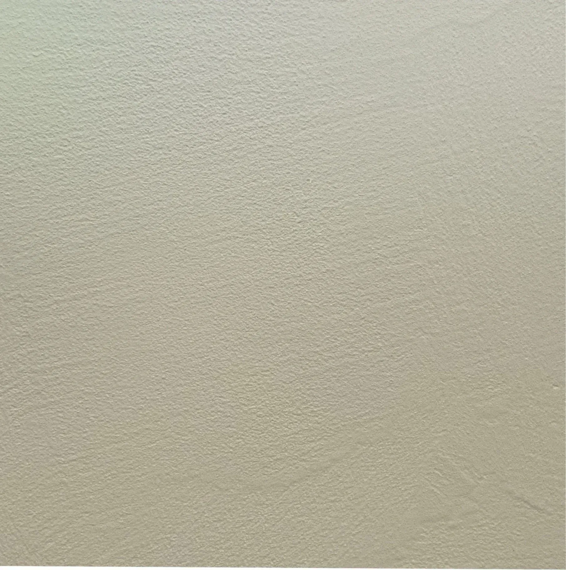 Textured, light-colored surface with a subtle gradient from a pale green to tan.