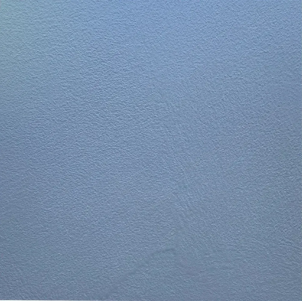Blue textured surface with a subtle gradient and fine grain pattern