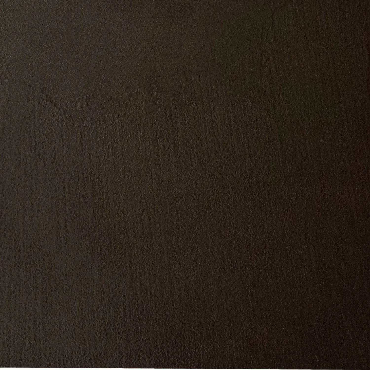 Dark brown, textured surface with slight variations in color and tone.