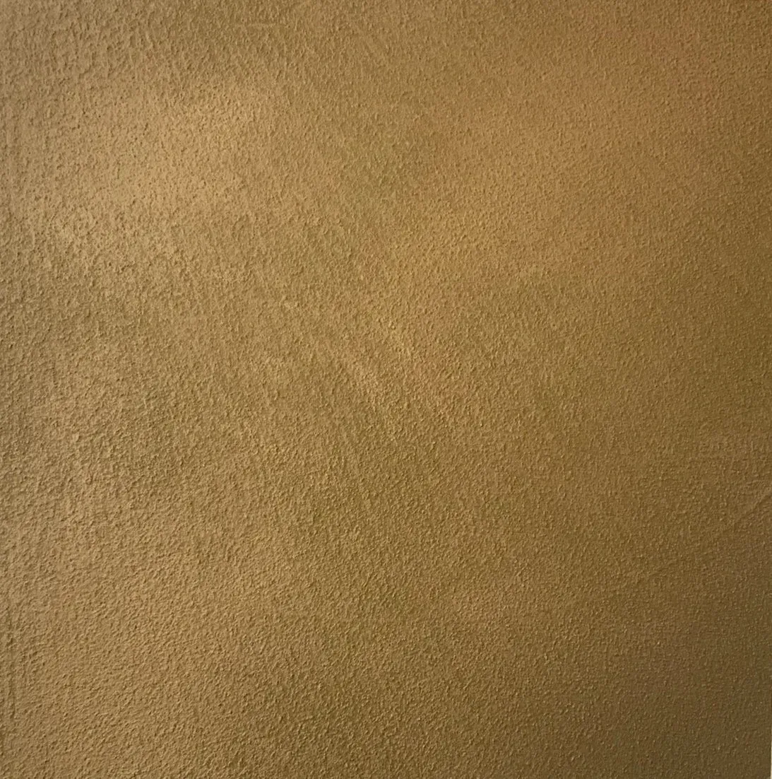 Textured, golden-brown wall surface.