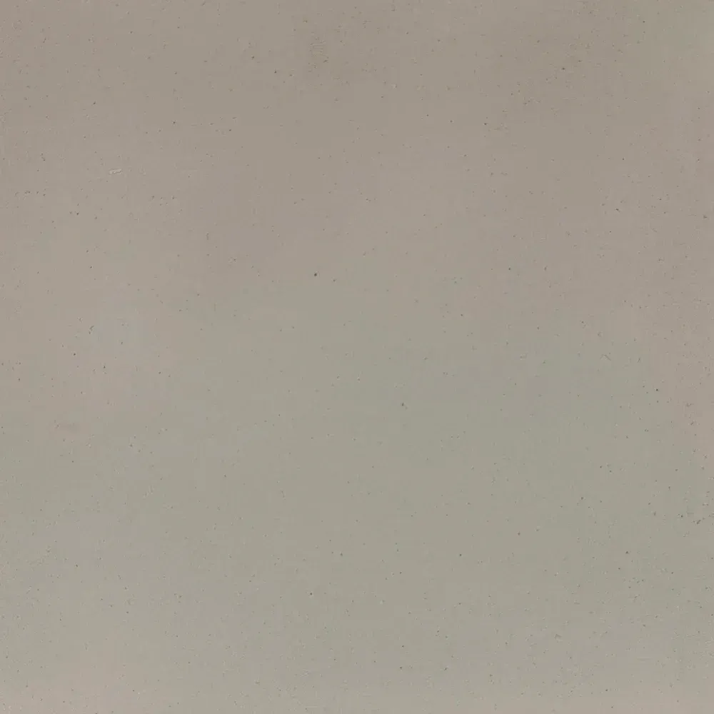 Plain beige wall with faint speckles and a few tiny marks.