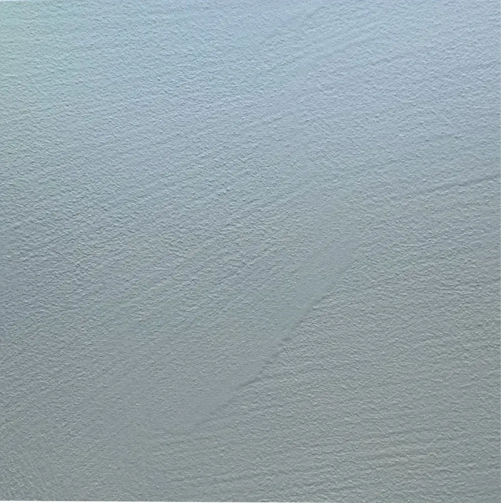 Close-up of pale blue-gray textured surface with subtle diagonal lines and ripples