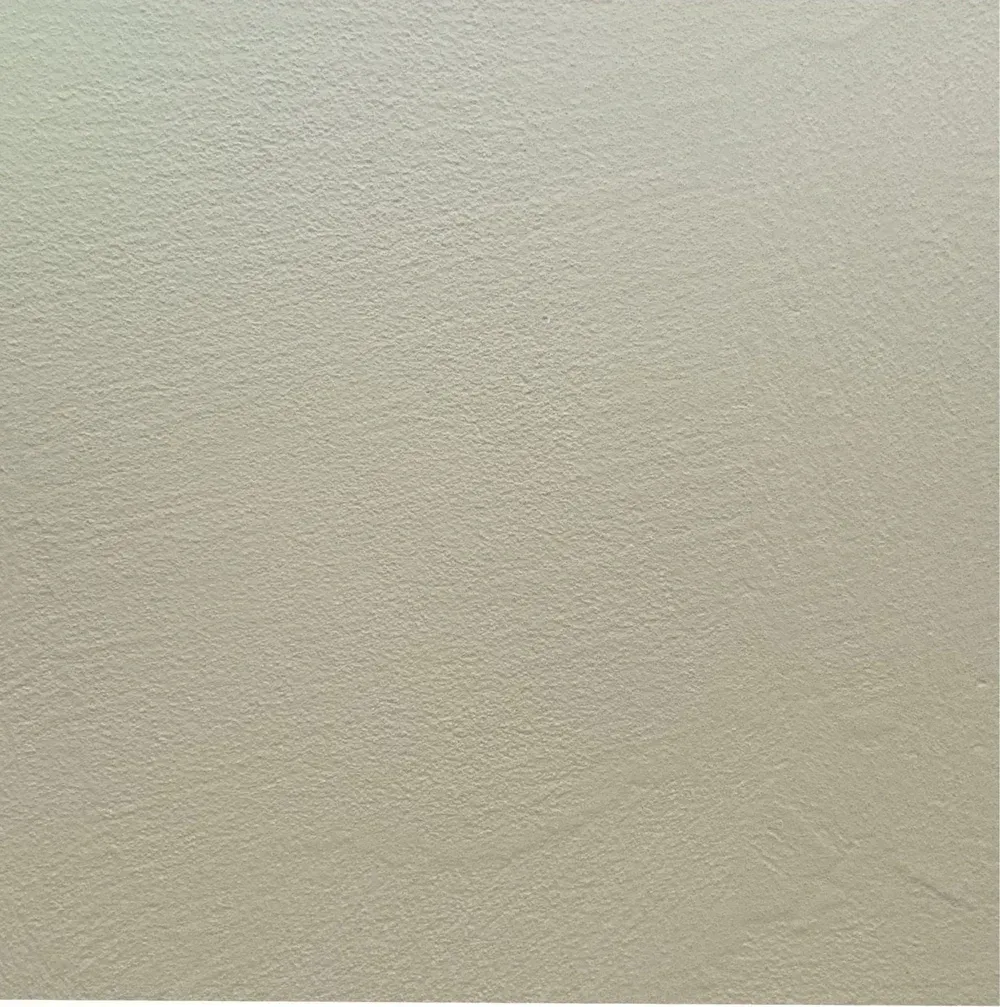 Close-up of a textured beige wall with subtle shadowing
