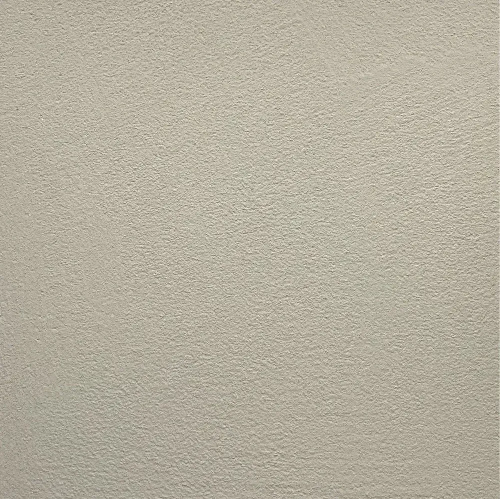 Close-up of a beige textured wall or ceiling surface