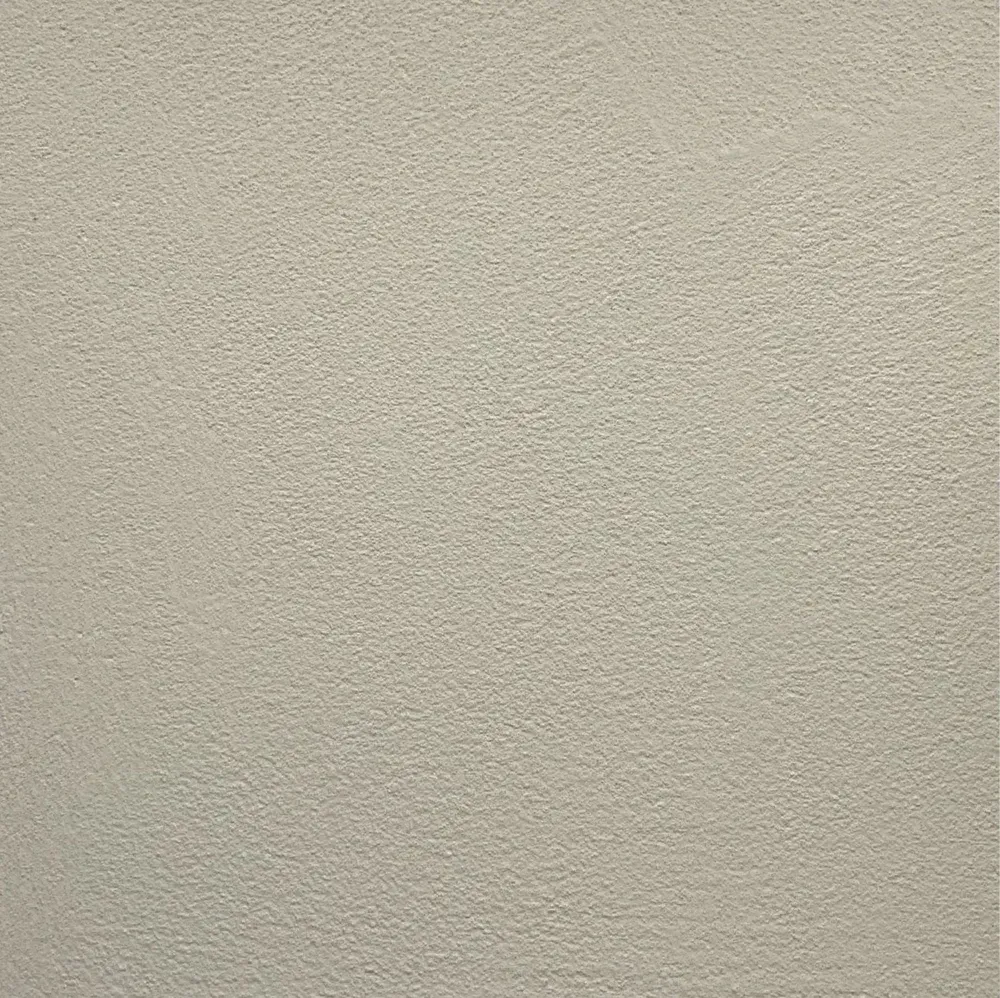 Light beige, textured wall surface.