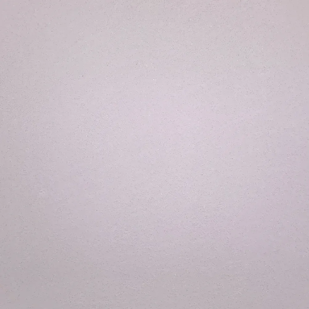 Close-up of a pale pink textured wall or blank surface with soft lighting
