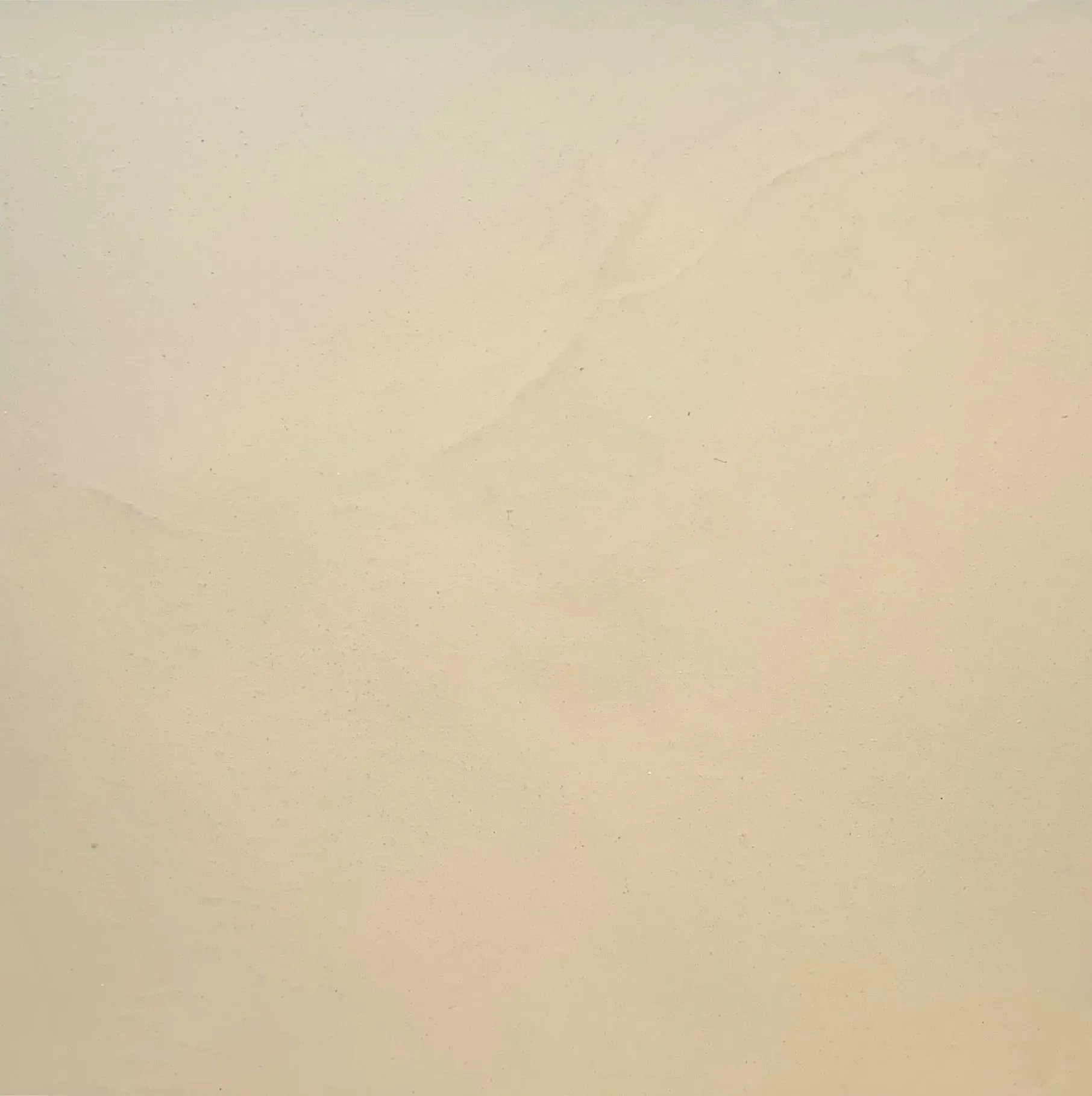 Beige-colored surface with subtle variations in tone.