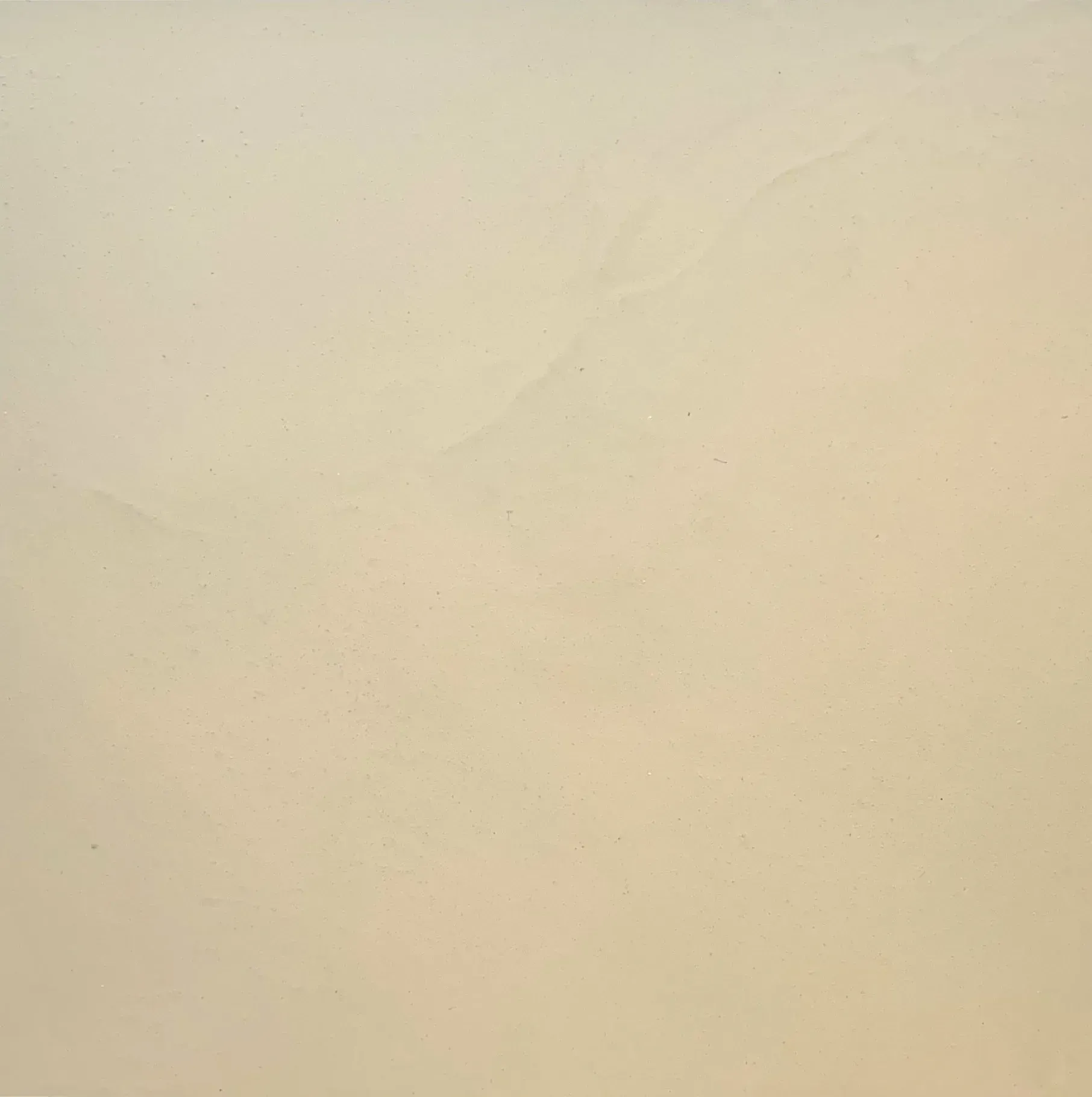 Beige-colored surface with subtle variations in tone.