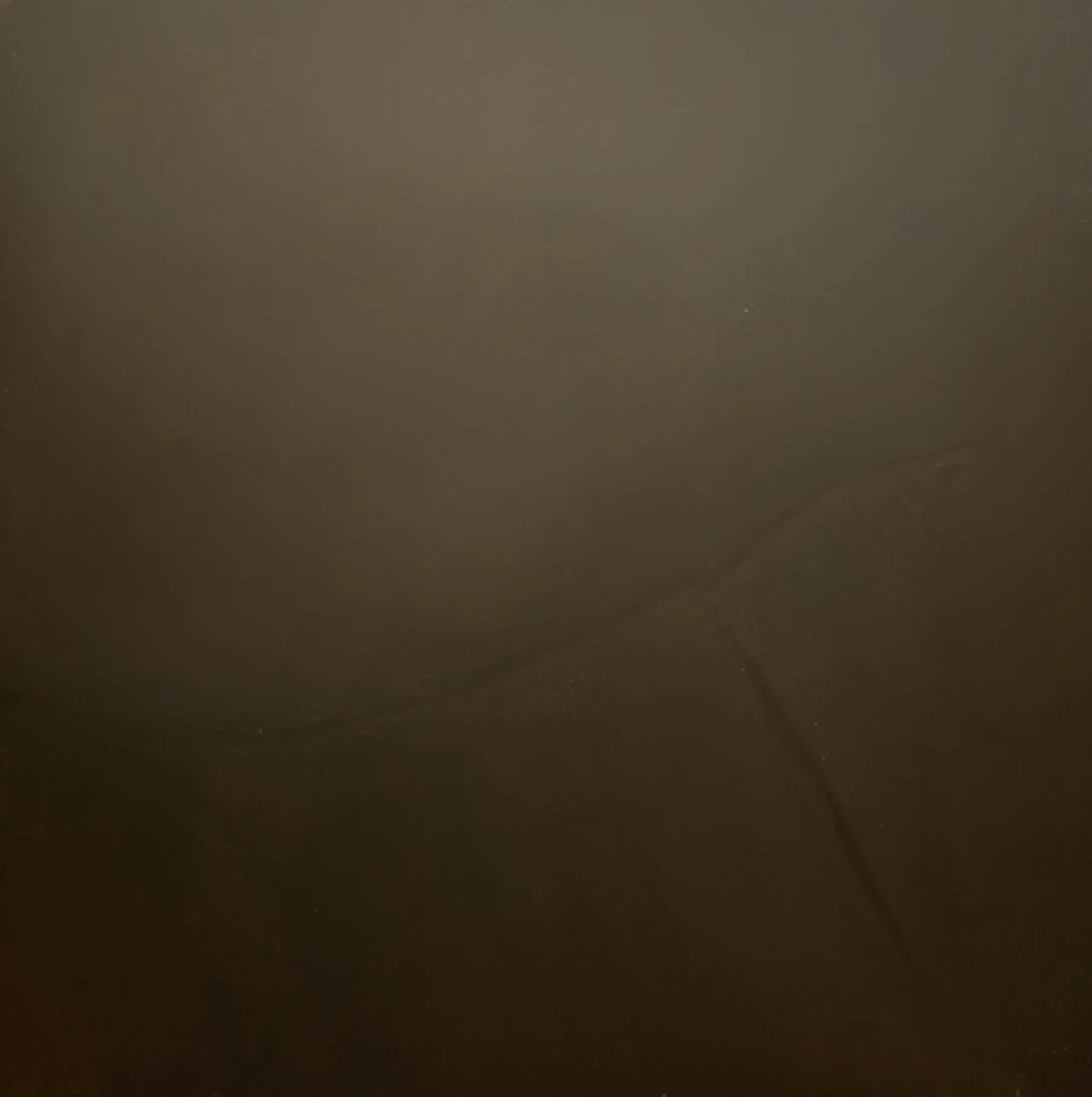 Plain brown wall, slightly darker at the bottom with a vertical crack.