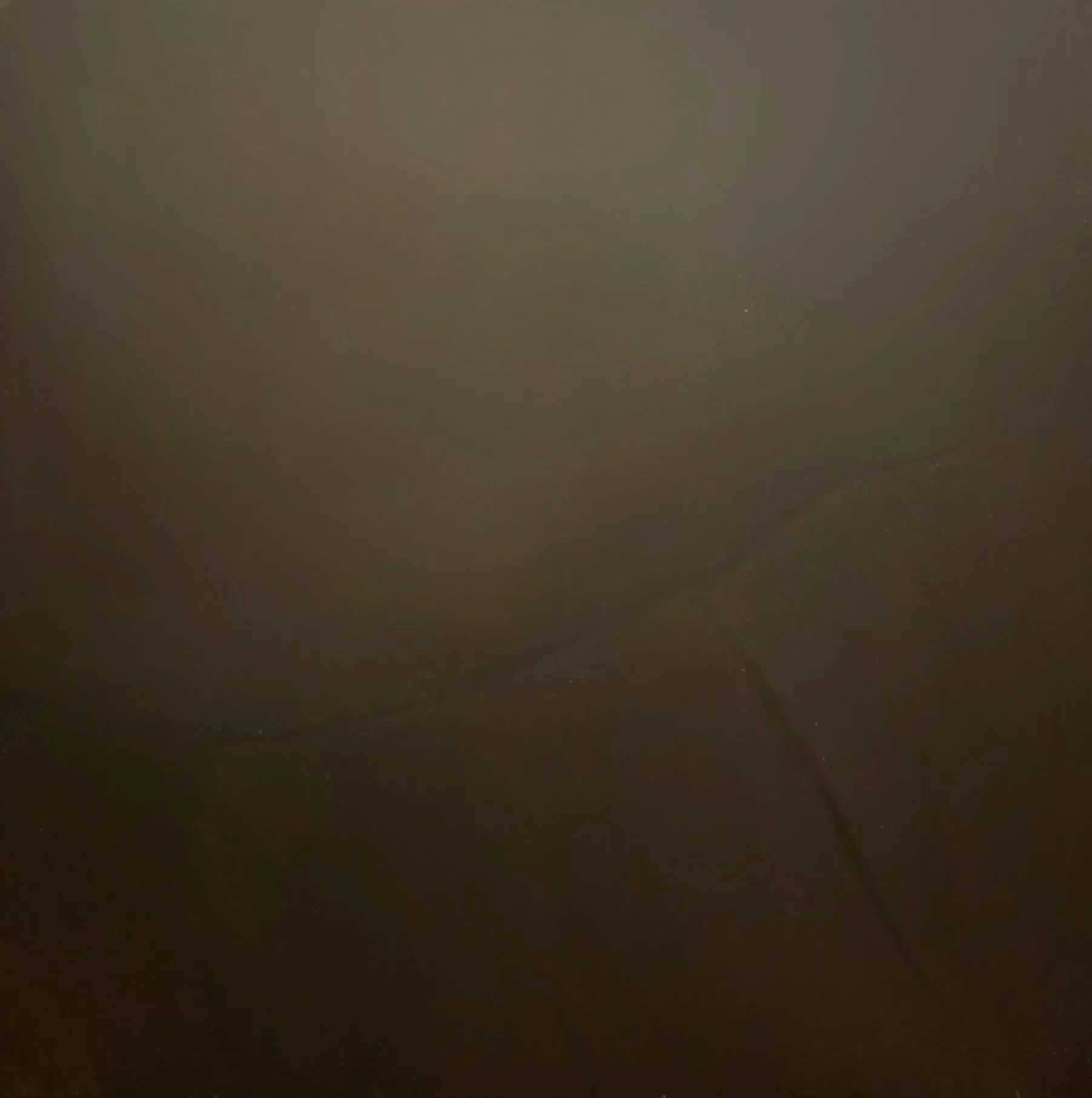 Plain brown wall, slightly darker at the bottom with a vertical crack.