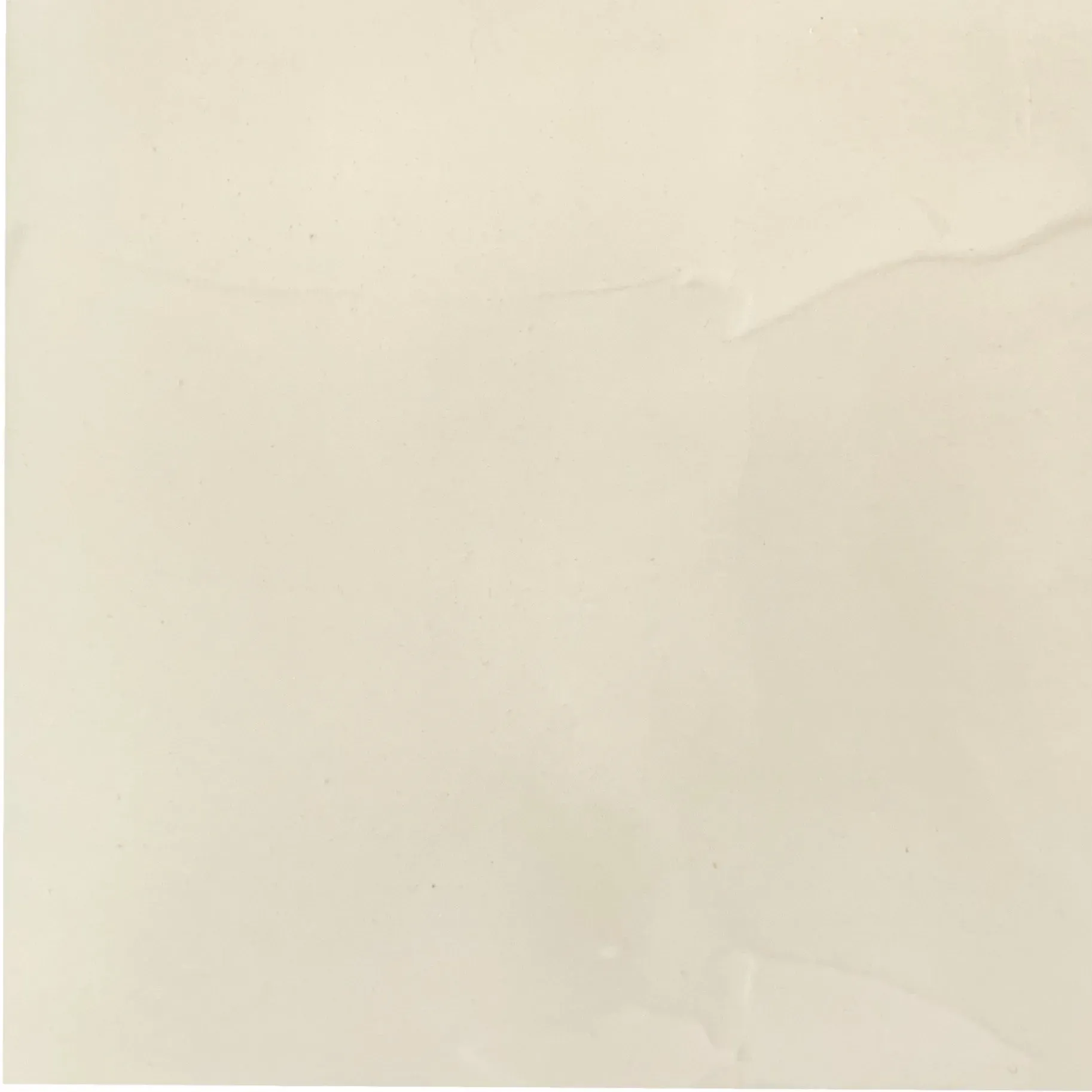 Light beige square with a slightly irregular surface, likely a tile.