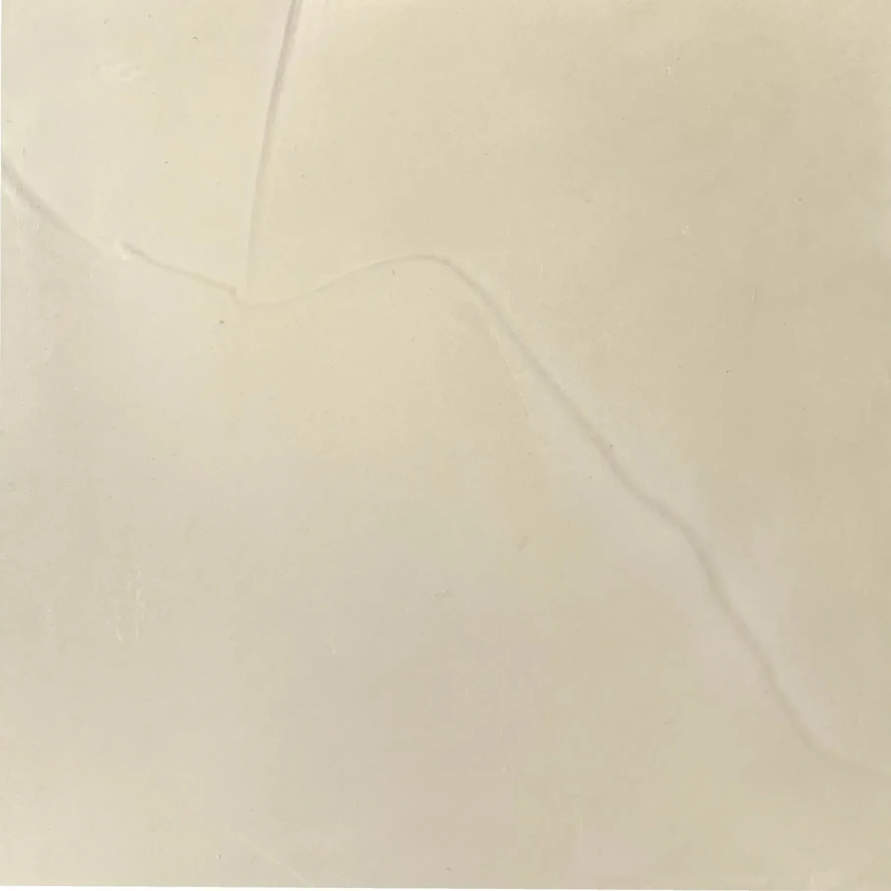 Cream-colored square tile with a faint diagonal gray vein.