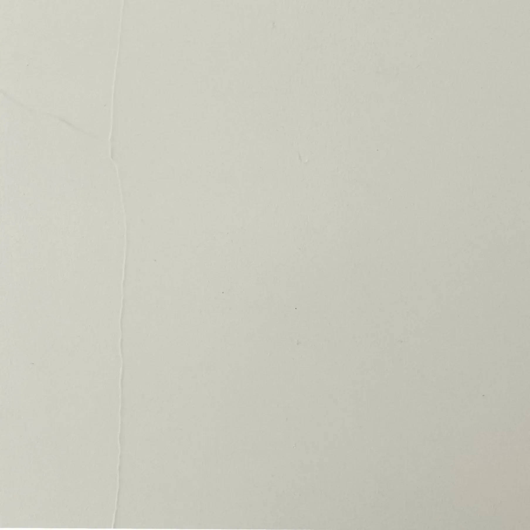 Light gray wall with a vertical seam.