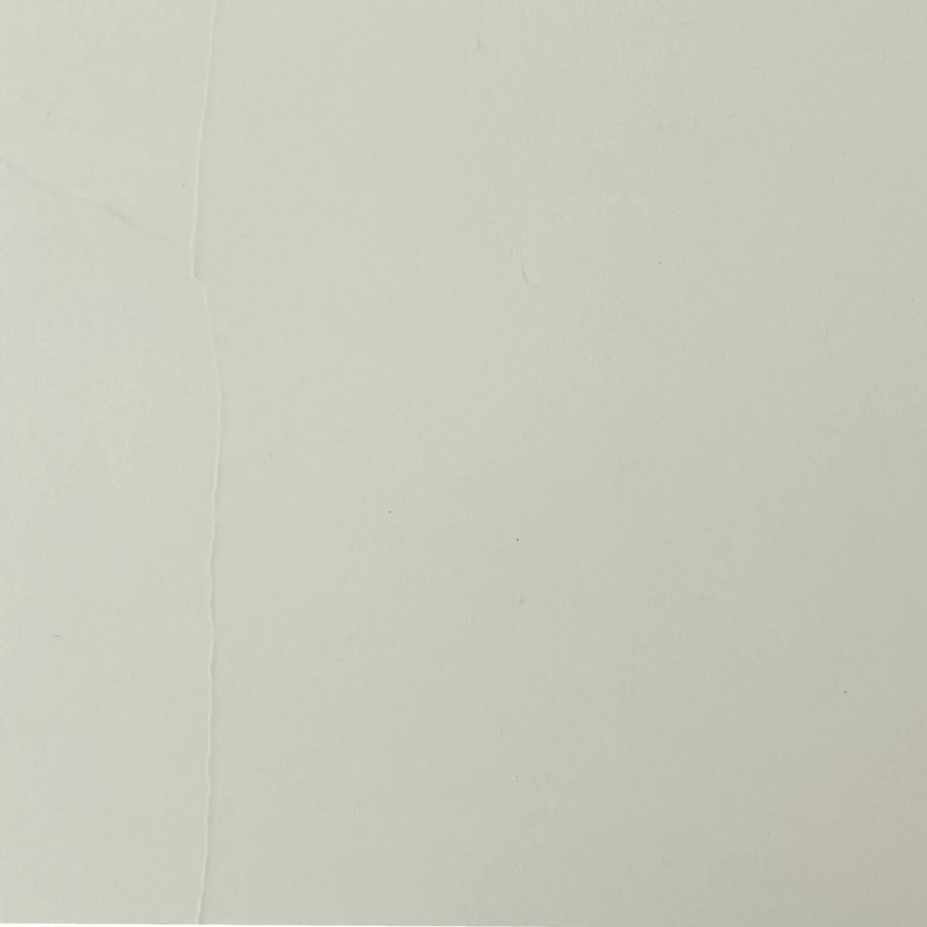 Light gray wall with a vertical seam.