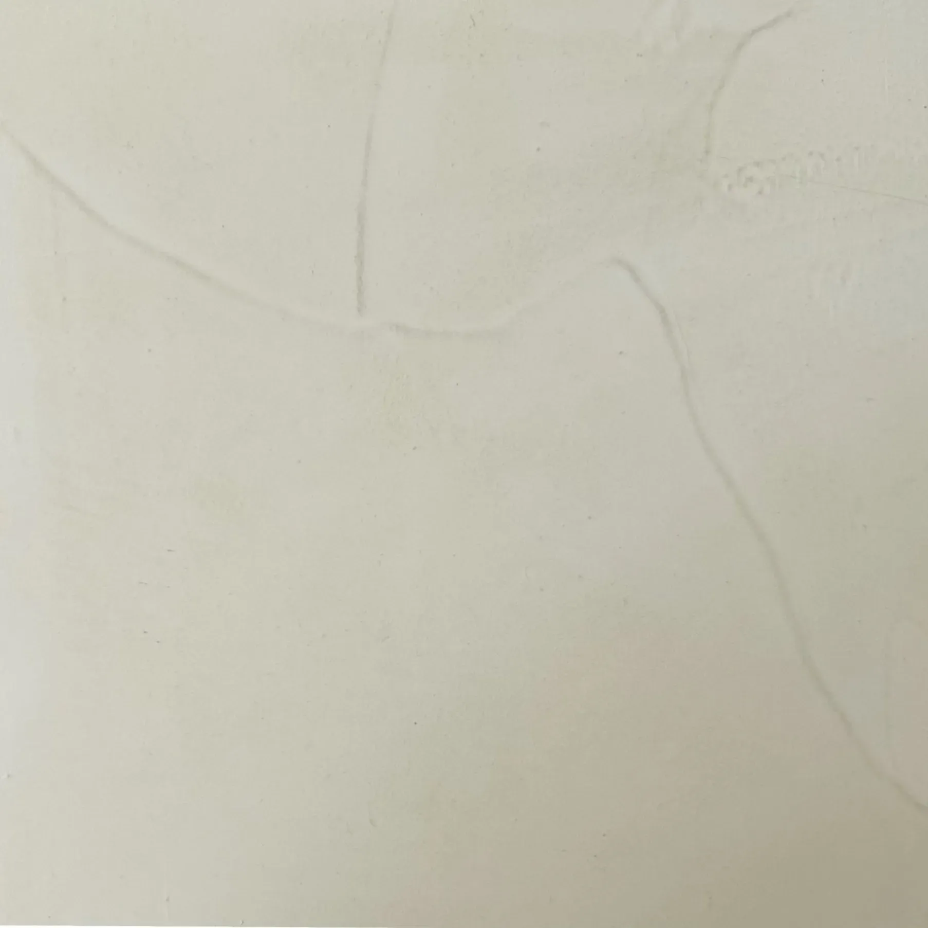 Off-white wall with faint cracks running across the surface.