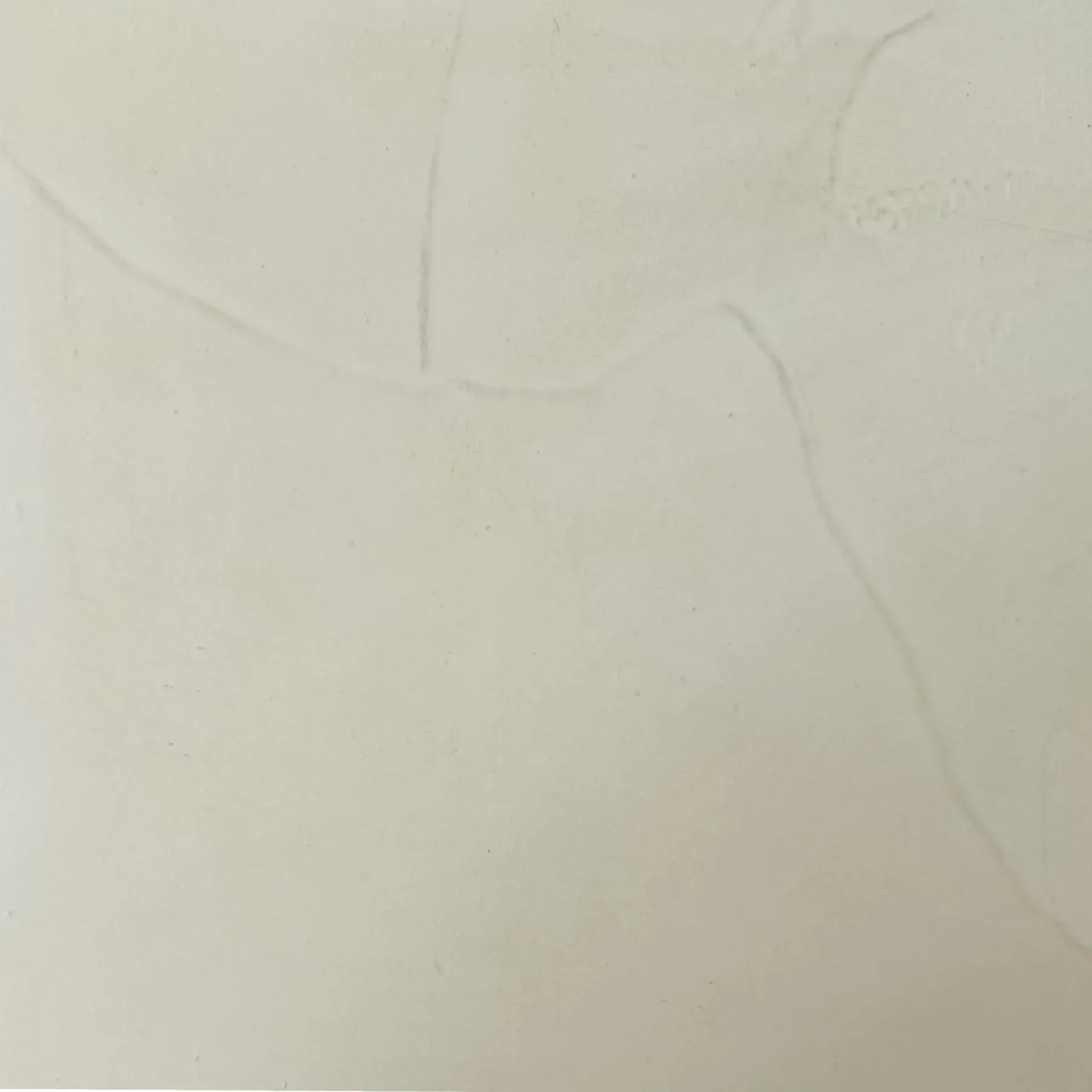 Off-white wall with faint cracks running across the surface.