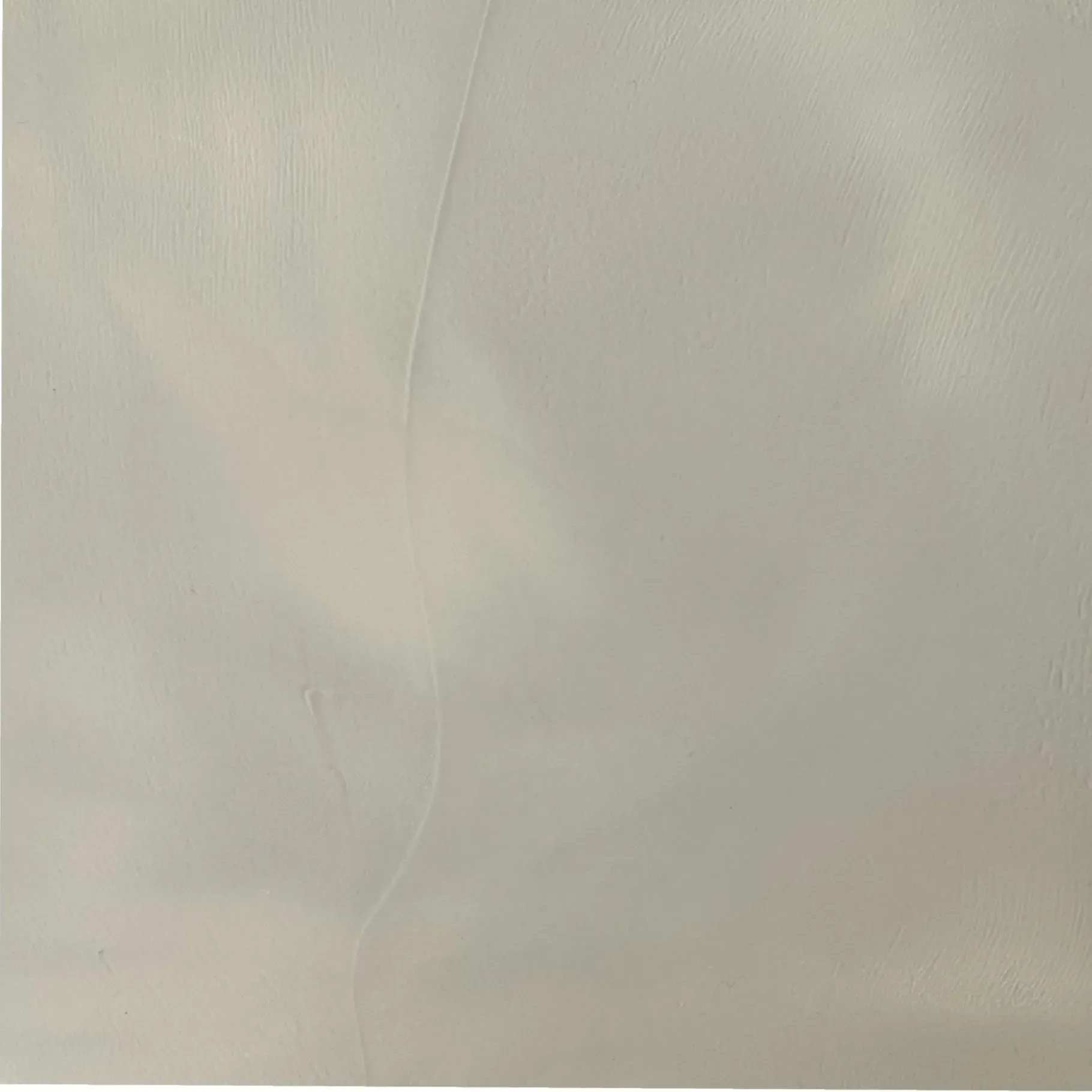 A plain, neutral gray background with subtle shading and faint vertical lines.