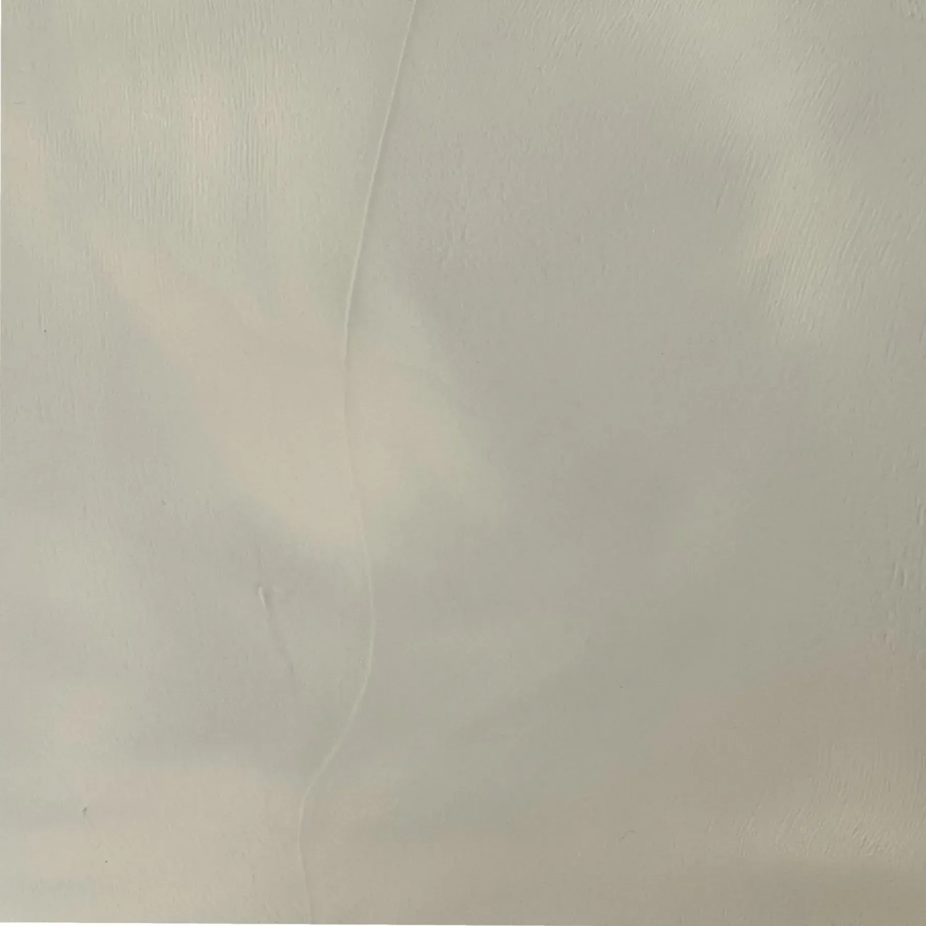 Textured pale gray wall surface with faint variations.