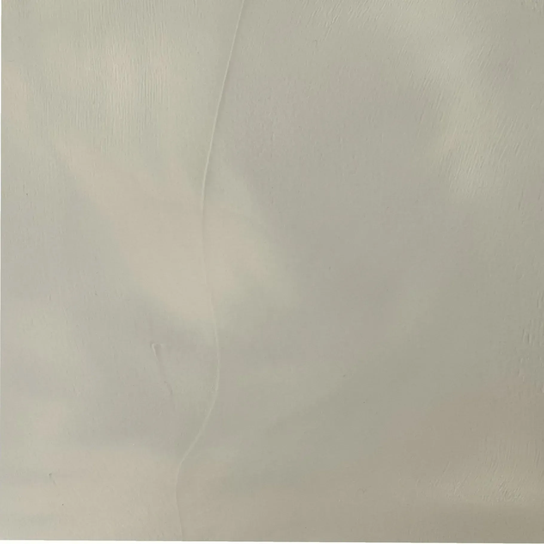 A plain, neutral gray background with subtle shading and faint vertical lines.