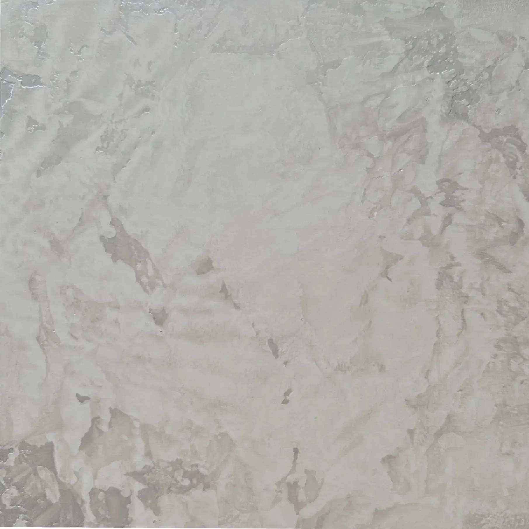 Textured wall with mottled, light gray plaster finish.