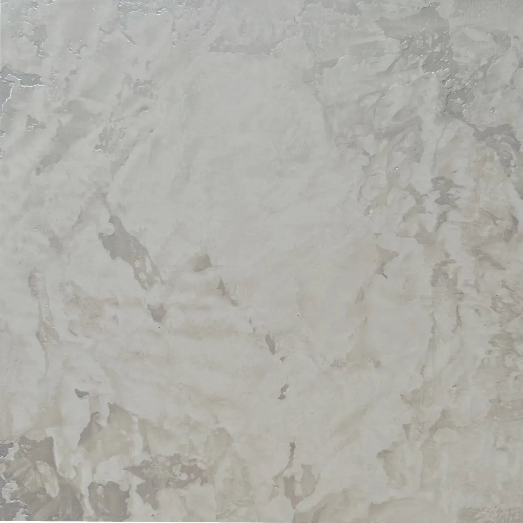 Textured wall with mottled, light gray plaster finish.