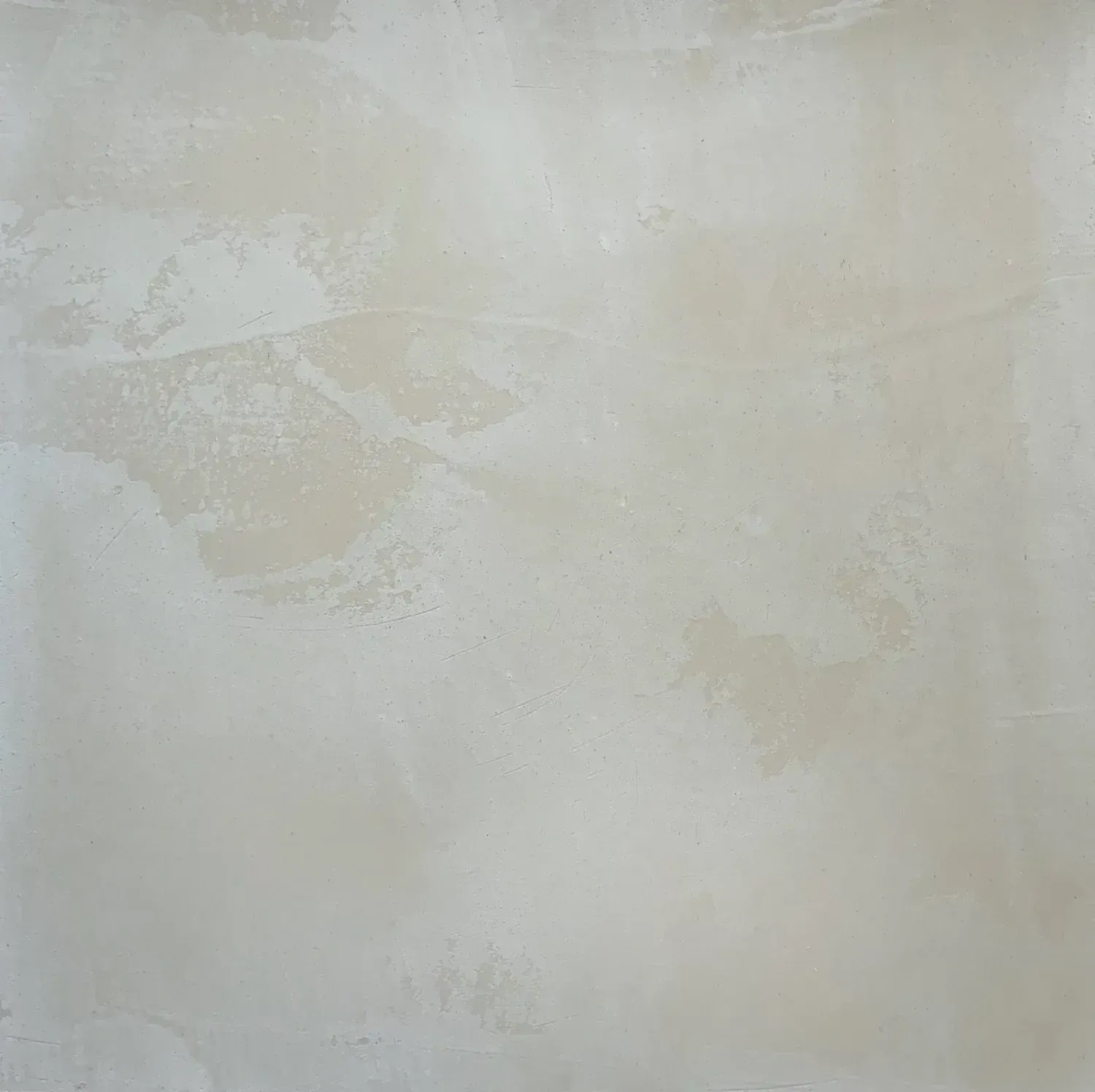 Light beige textured wall or plaster surface with subtle mottled patches