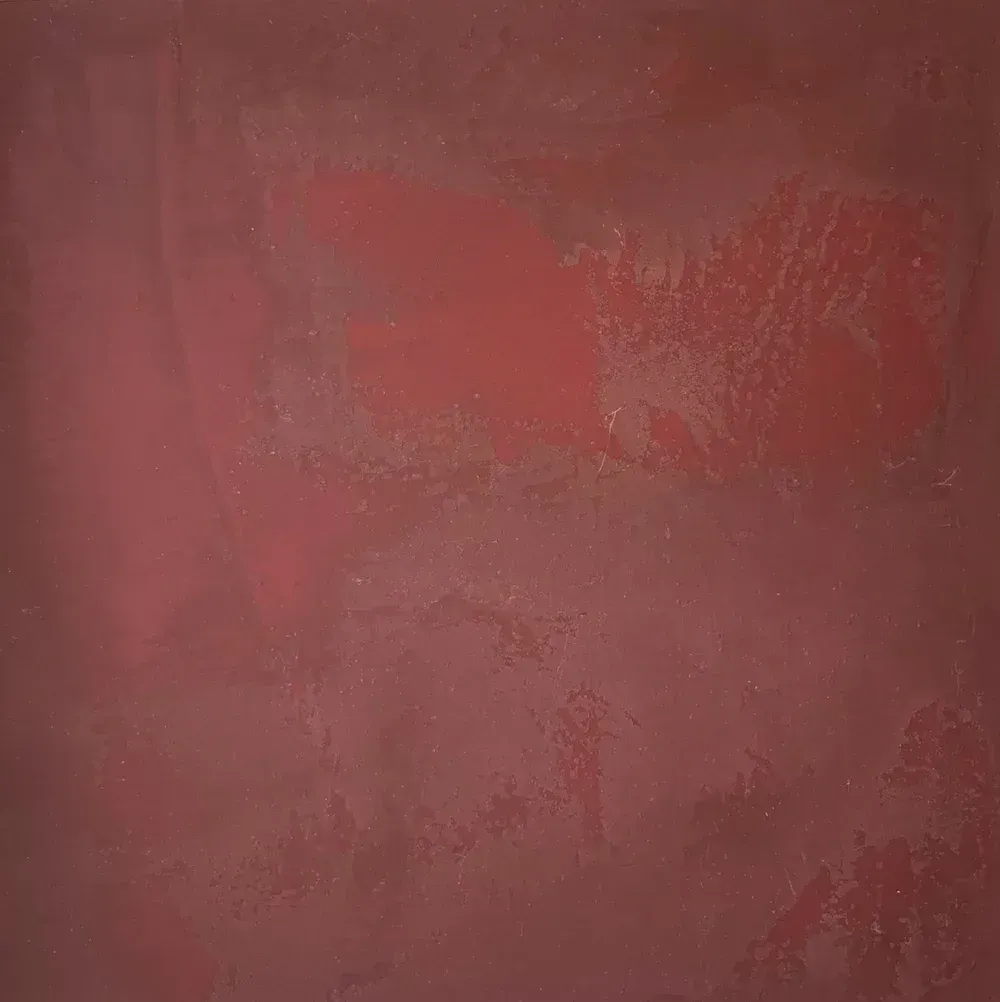 Abstract reddish-brown textured surface with faded pink patches and rough, mottled areas