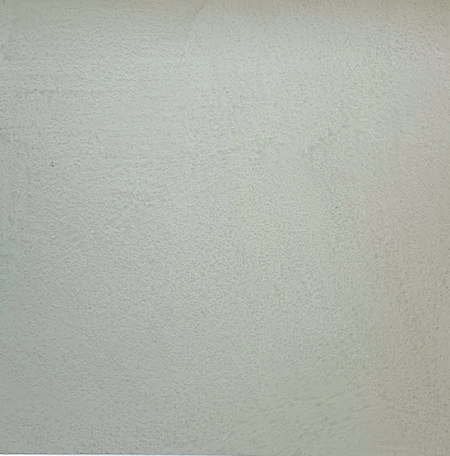 Gray, textured wall surface.