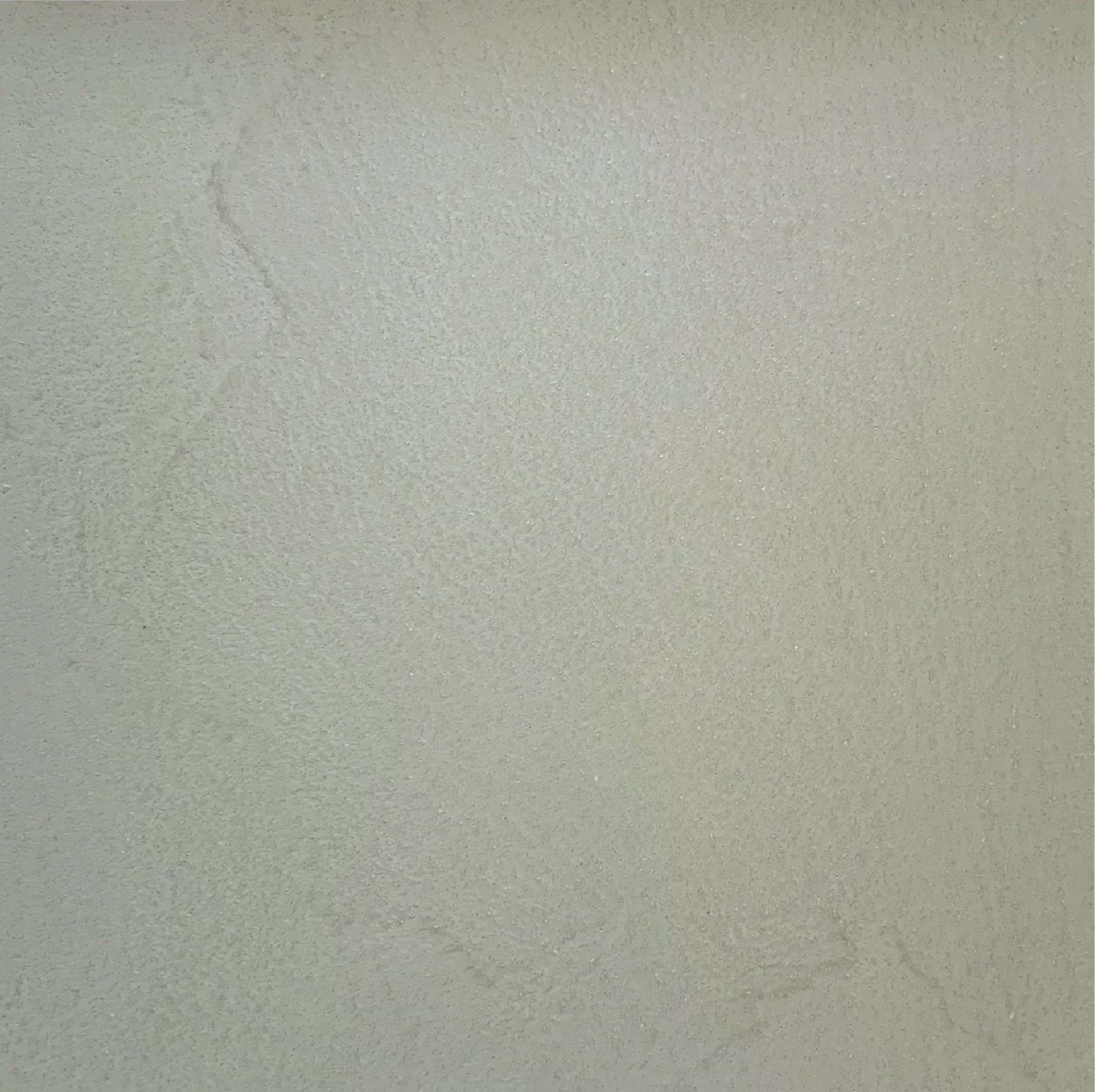 Light beige, textured wall surface.