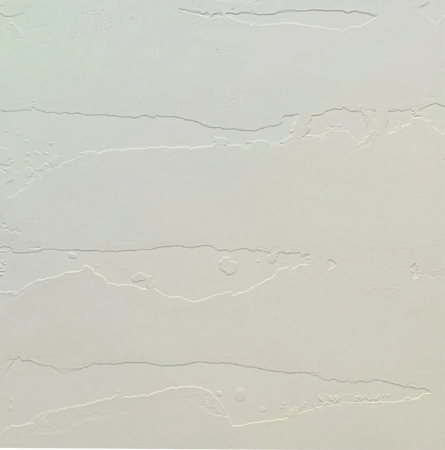 Textured, pale-colored wall with horizontal, slightly raised bands and a subtle color gradient.
