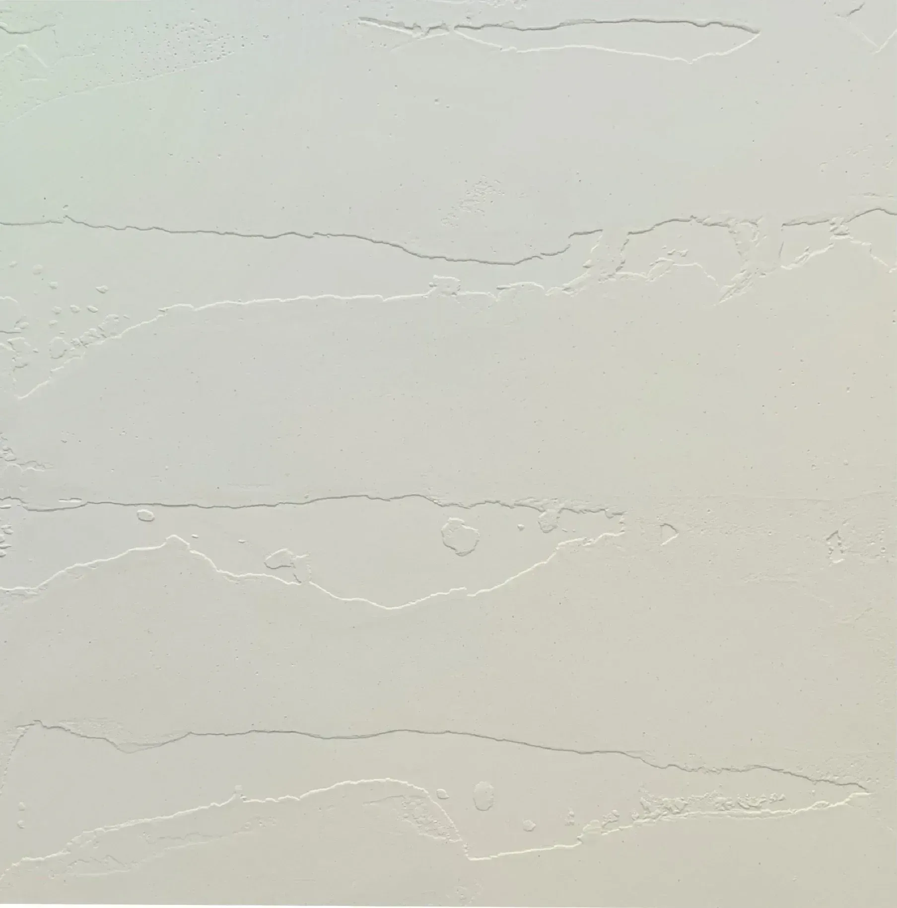Close-up of a light beige textured wall with subtle horizontal cracks and wavy lines