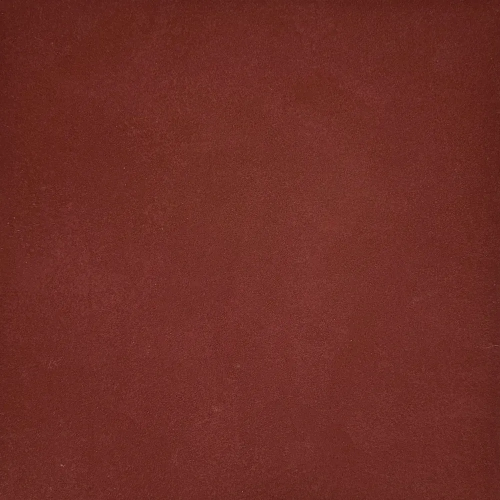 Solid, dark reddish-brown background.