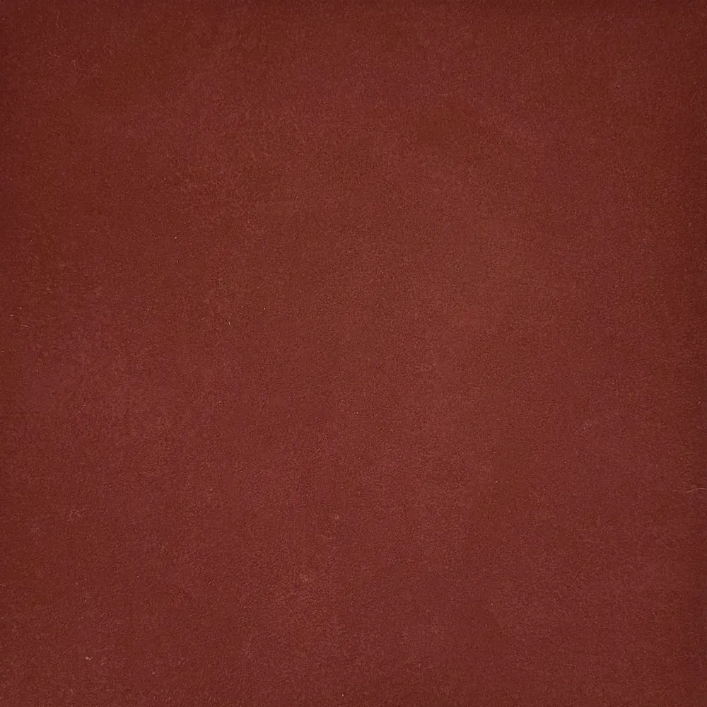 Close-up of a blurry reddish-brown surface with soft lighting