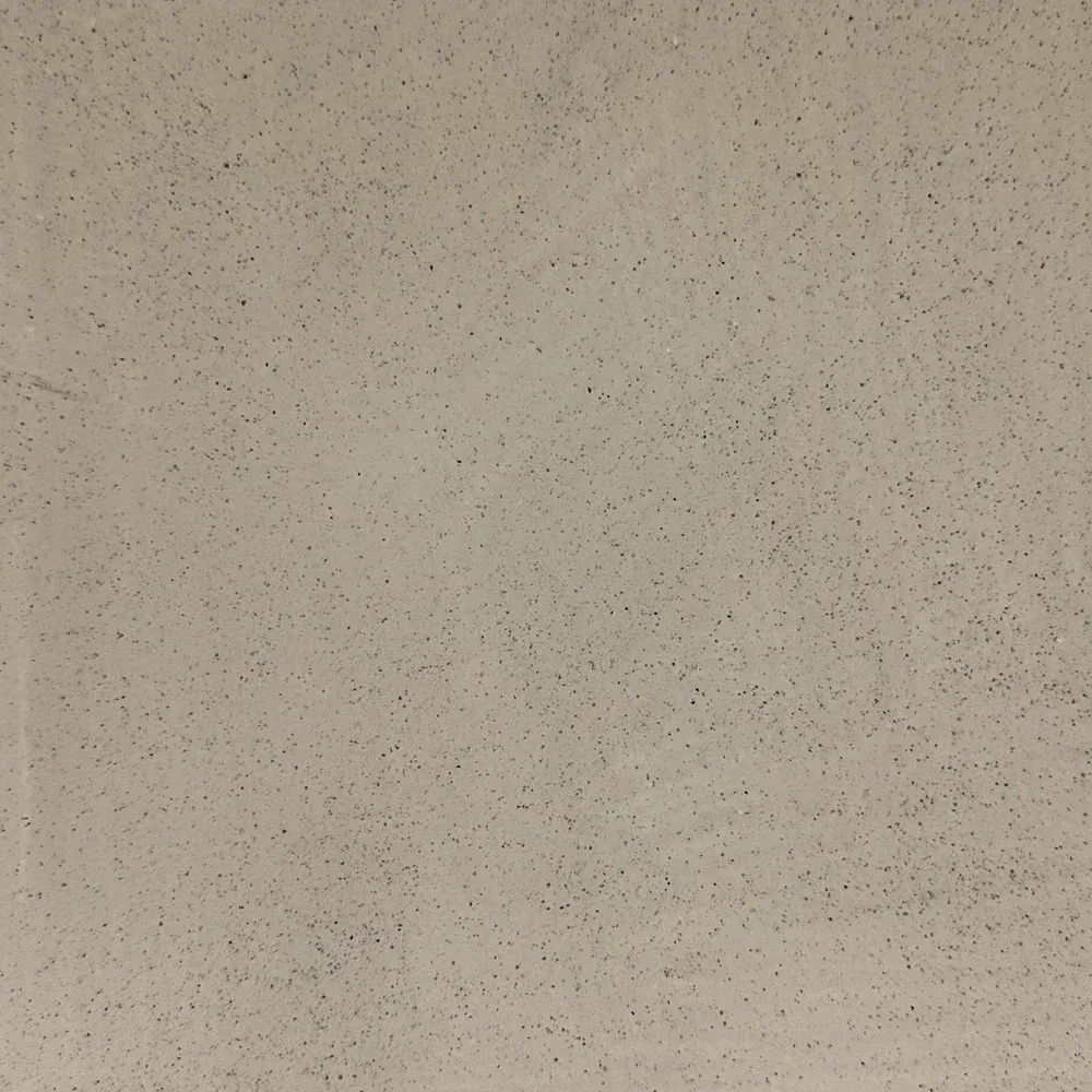 Beige speckled textured surface filling the frame