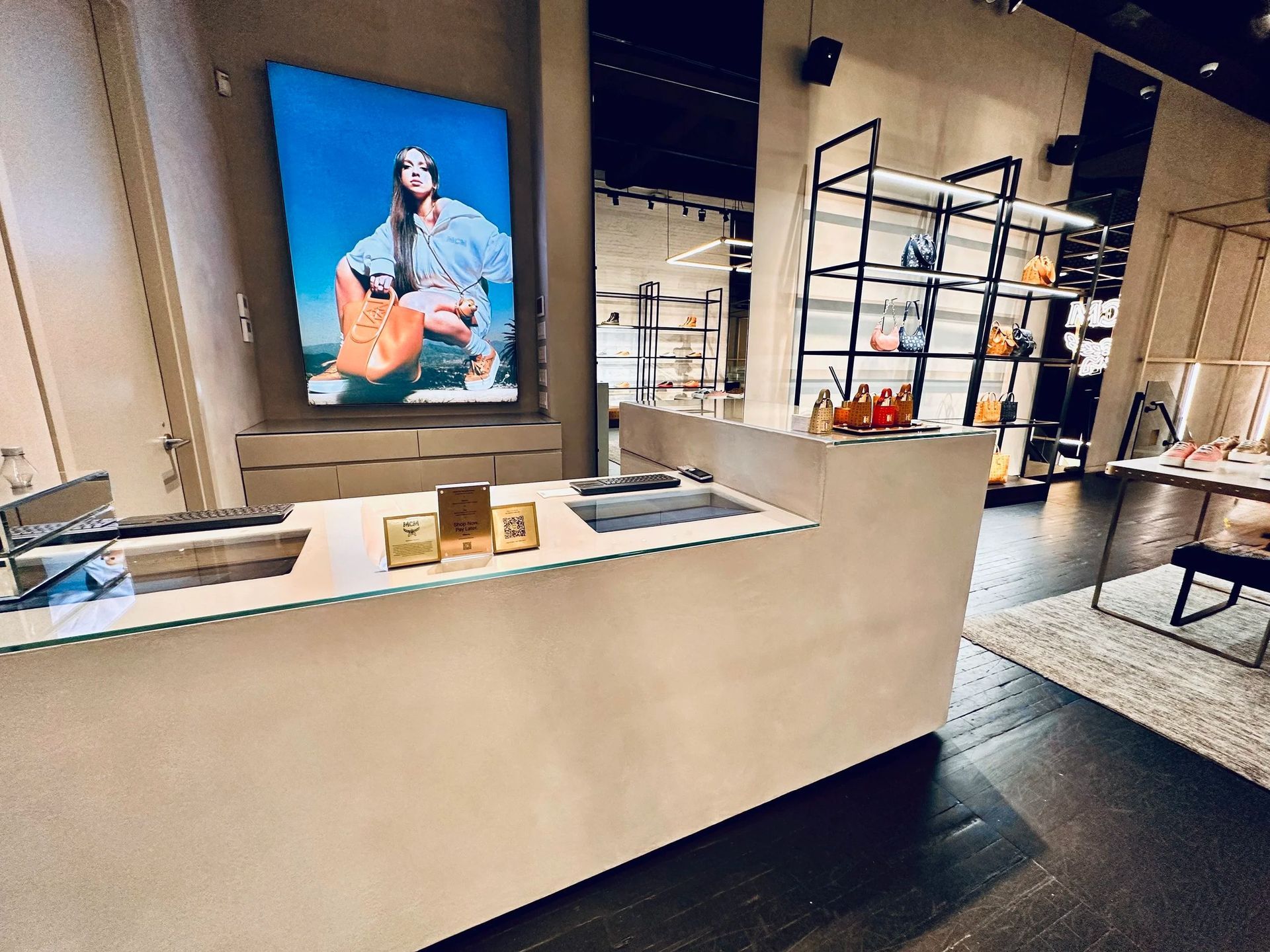 Cashier counter inside a retail store with a large photo on the wall and product displays in the background.