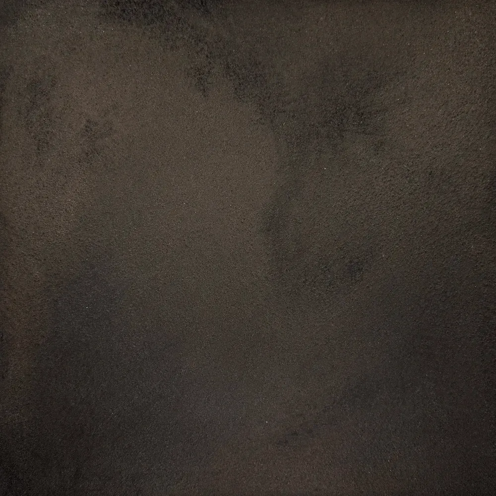 Dark, blurry close-up of a shadowy face-like shape against a black background