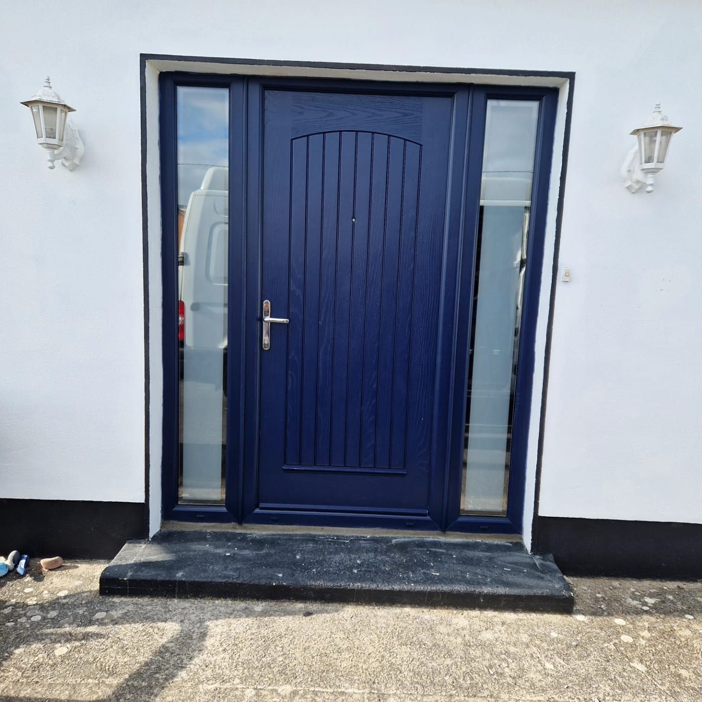 A blue door with a white wall behind it